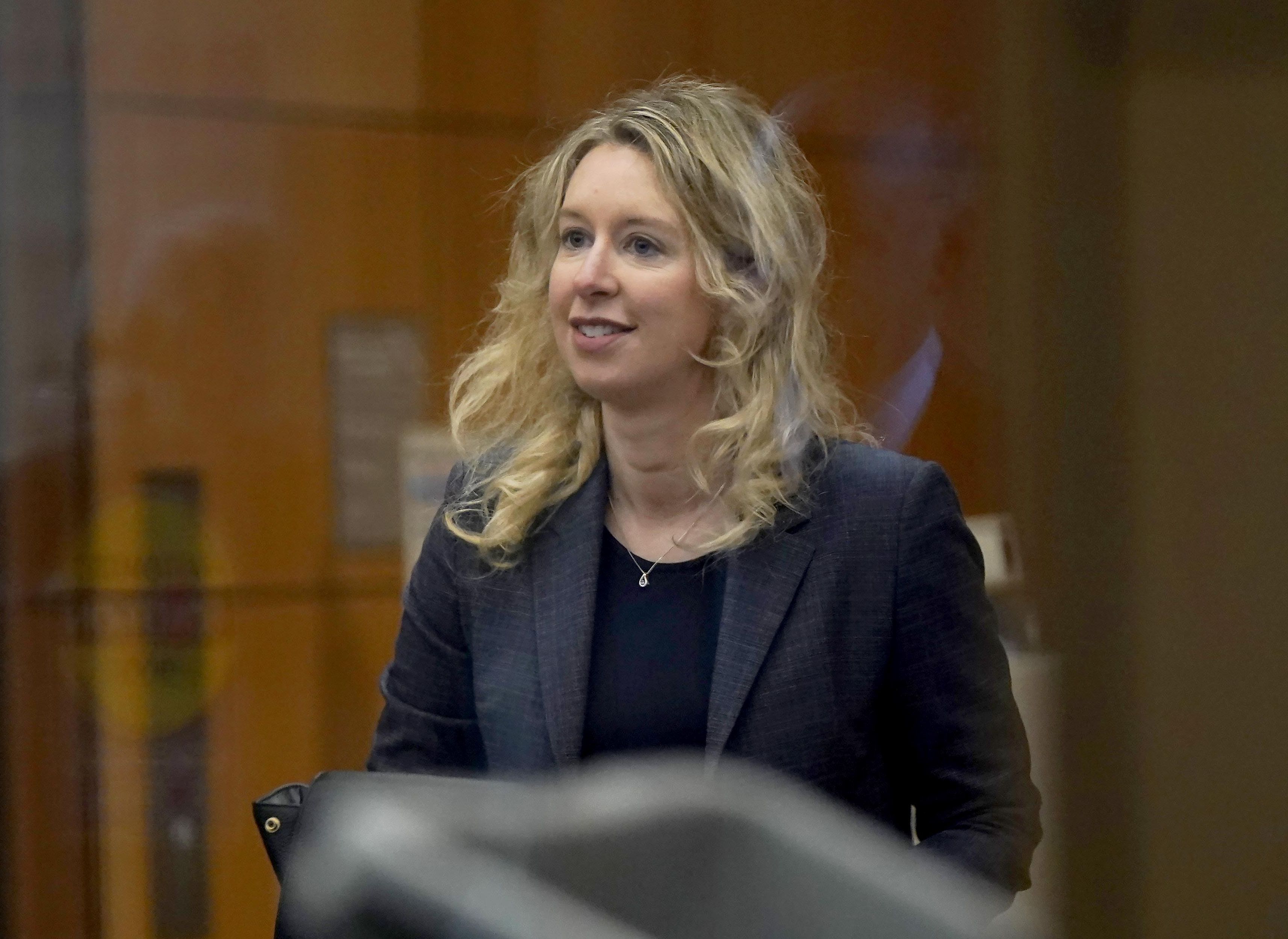Former Theranos CEO Elizabeth Holmes arrives at federal court in San Jose, Calif., on Monday. A key witness in the January trial that led to multiple convictions for the disgraced Holmes was back on the stand Monday to revisit his testimony, part of an effort by Holmes' lawyers to secure a new trial for the 38-year-old Stanford dropout.