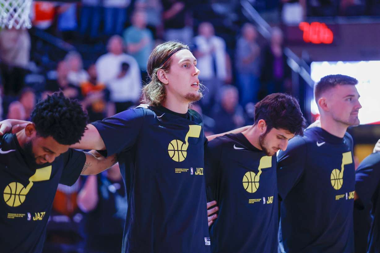 The Jazz lock arms during the national anthem before playing the Mavericks in a preseason game in Salt Lake City on Friday, Oct. 14, 2022. The Mavericks won 115-101.