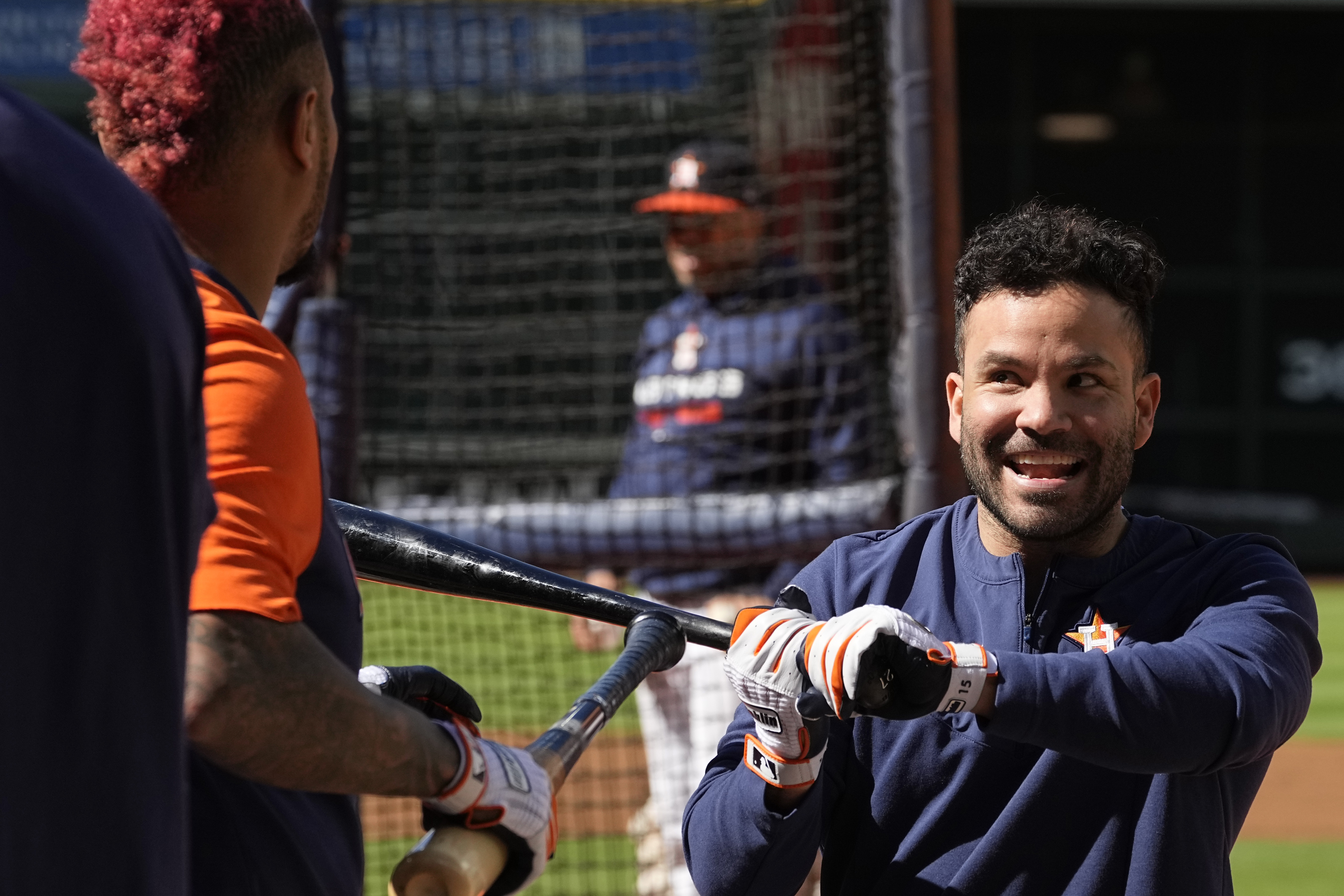 Houston Astros second baseman Jose Altuve, right, jokes with catcher Martin Maldonado during a practice ahead of Game 1 of baseball's American League Championship Series, in Houston, Tuesday, Oct. 18, 2022. 