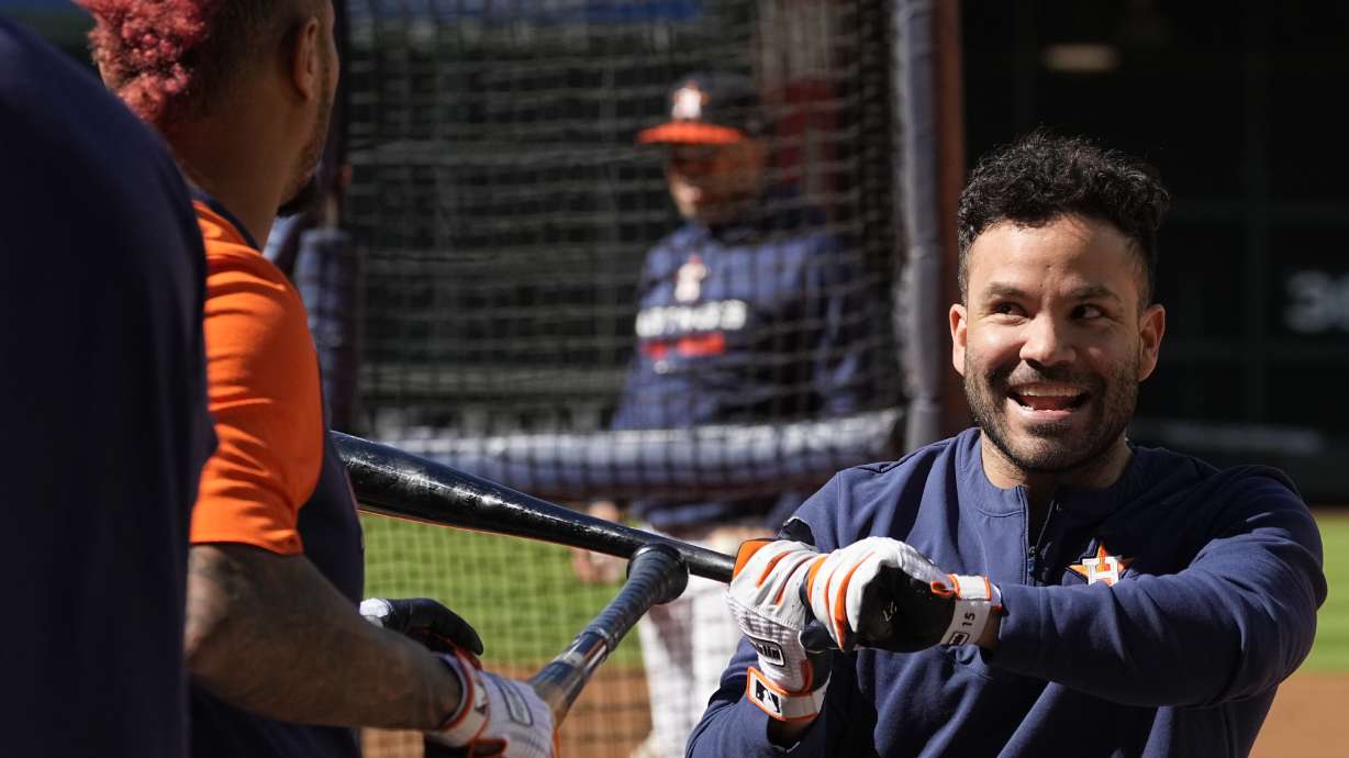 Houston Astros second baseman Jose Altuve, right, jokes with catcher Martin Maldonado during a practice ahead of Game 1 of baseball's American League Championship Series, in Houston, Tuesday, Oct. 18, 2022.