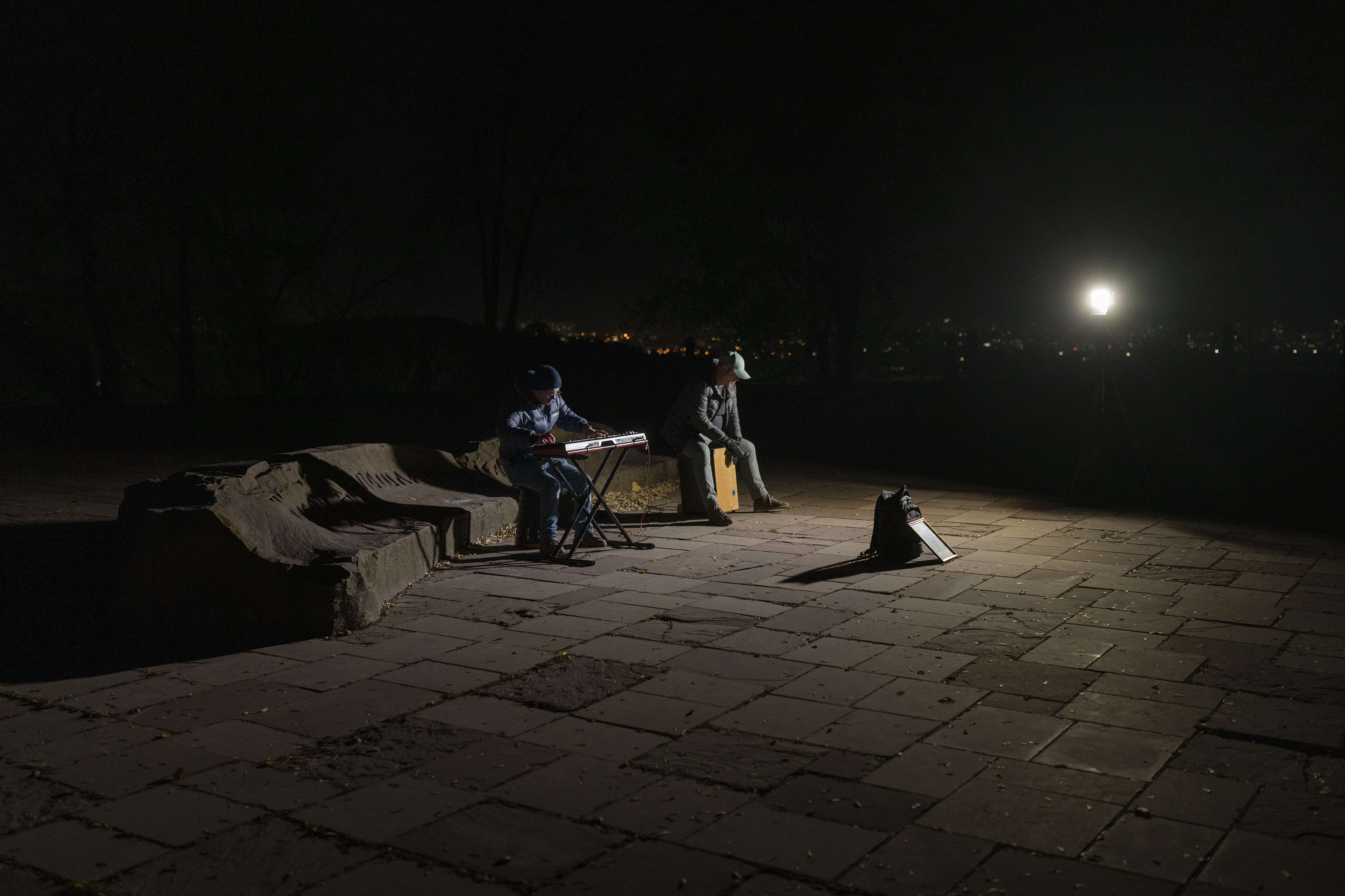 Street musicians play their instruments in a square without electric lights in Kyiv, Ukraine, Tuesday. 