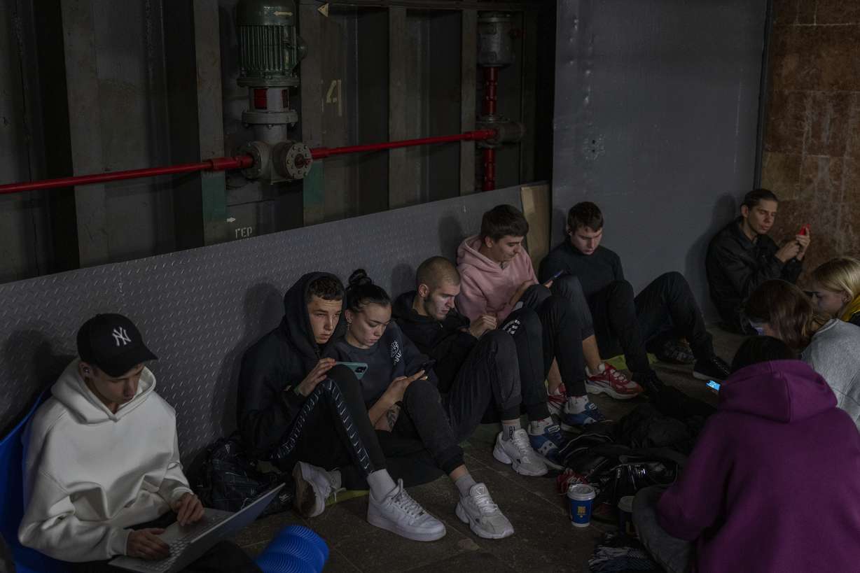 People sit in the Kyiv subway, using it as a bomb shelter, in Kyiv, Ukraine, on Wednesday.