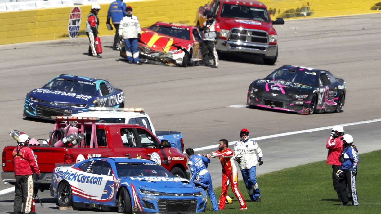 Bubba Wallace, center right, shoves Kyle Larson (5) after they crashed during a NASCAR Cup Series auto race at Las Vegas Motor Speedway in Las Vegas, Sunday, Oct. 16, 2022.