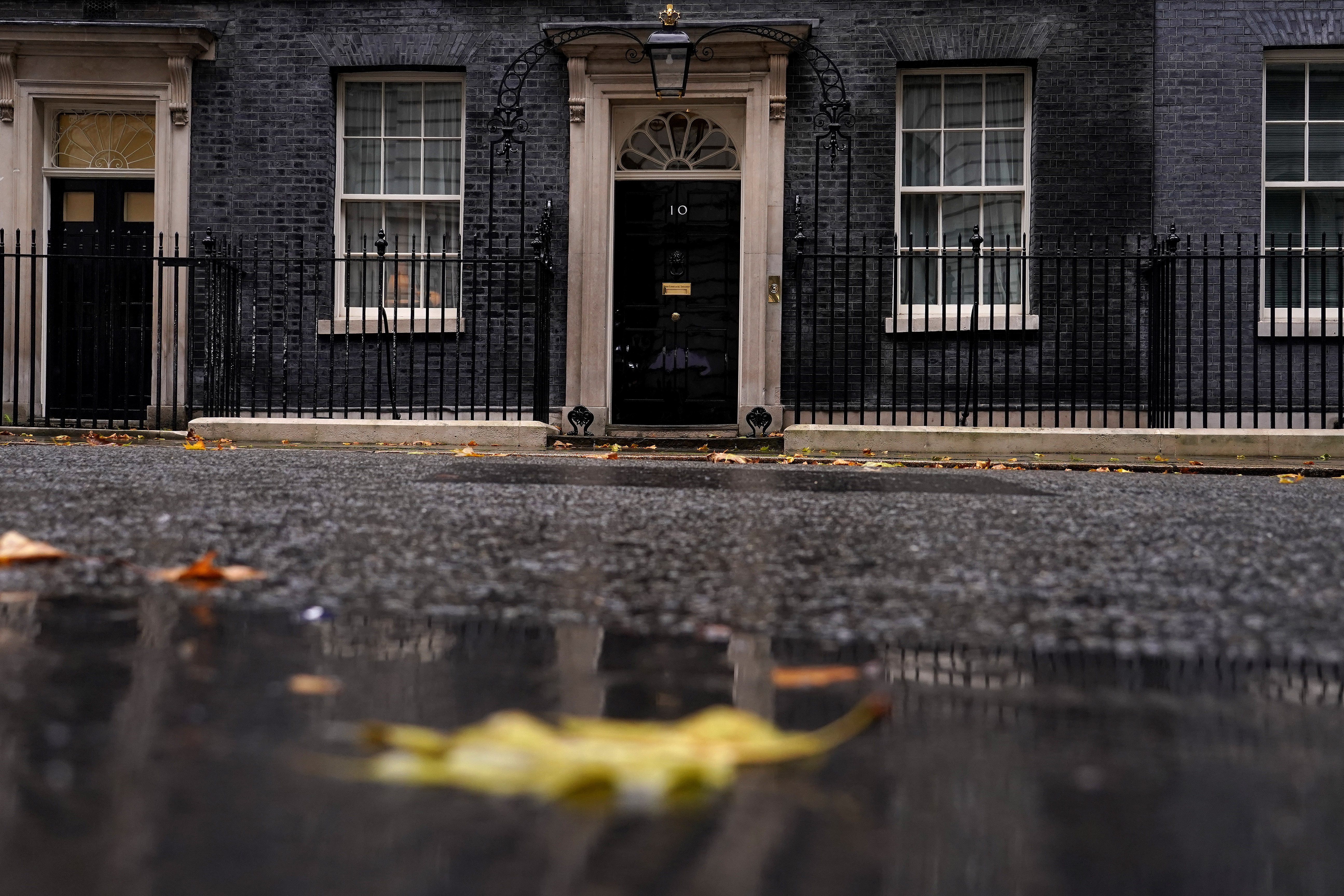 Rain and fallen leaves create an autumn atmosphere at 10 Downing Street in London, Thursday.