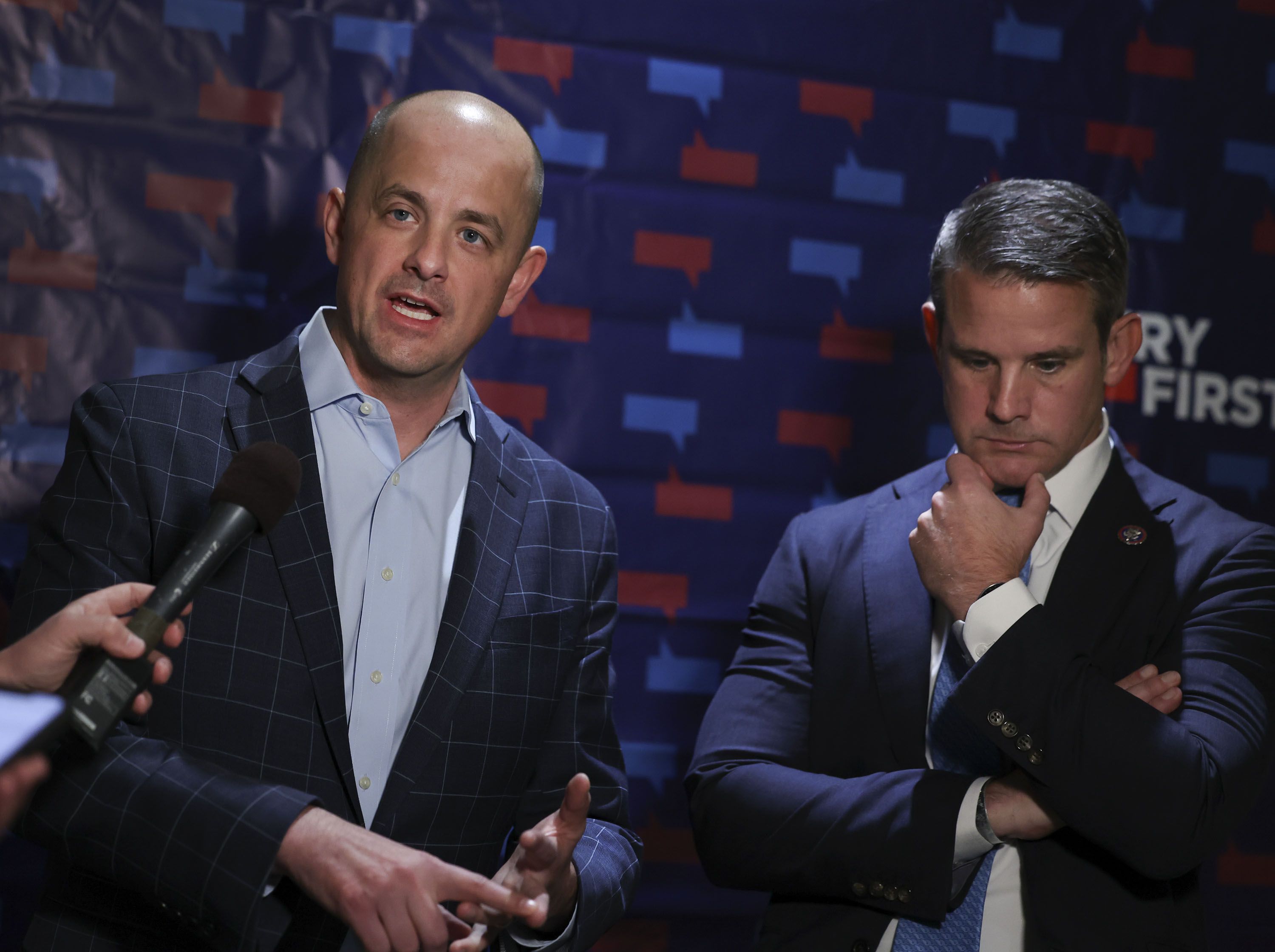 Evan McMullin, an independent candidate for U.S. Senate, left, and Rep. Adam Kinzinger, R-Ill., a member of U.S. House Jan. 6 Committee, speak to reporters following forum on democracy at the Salt Lake City Public Library on Thursday.