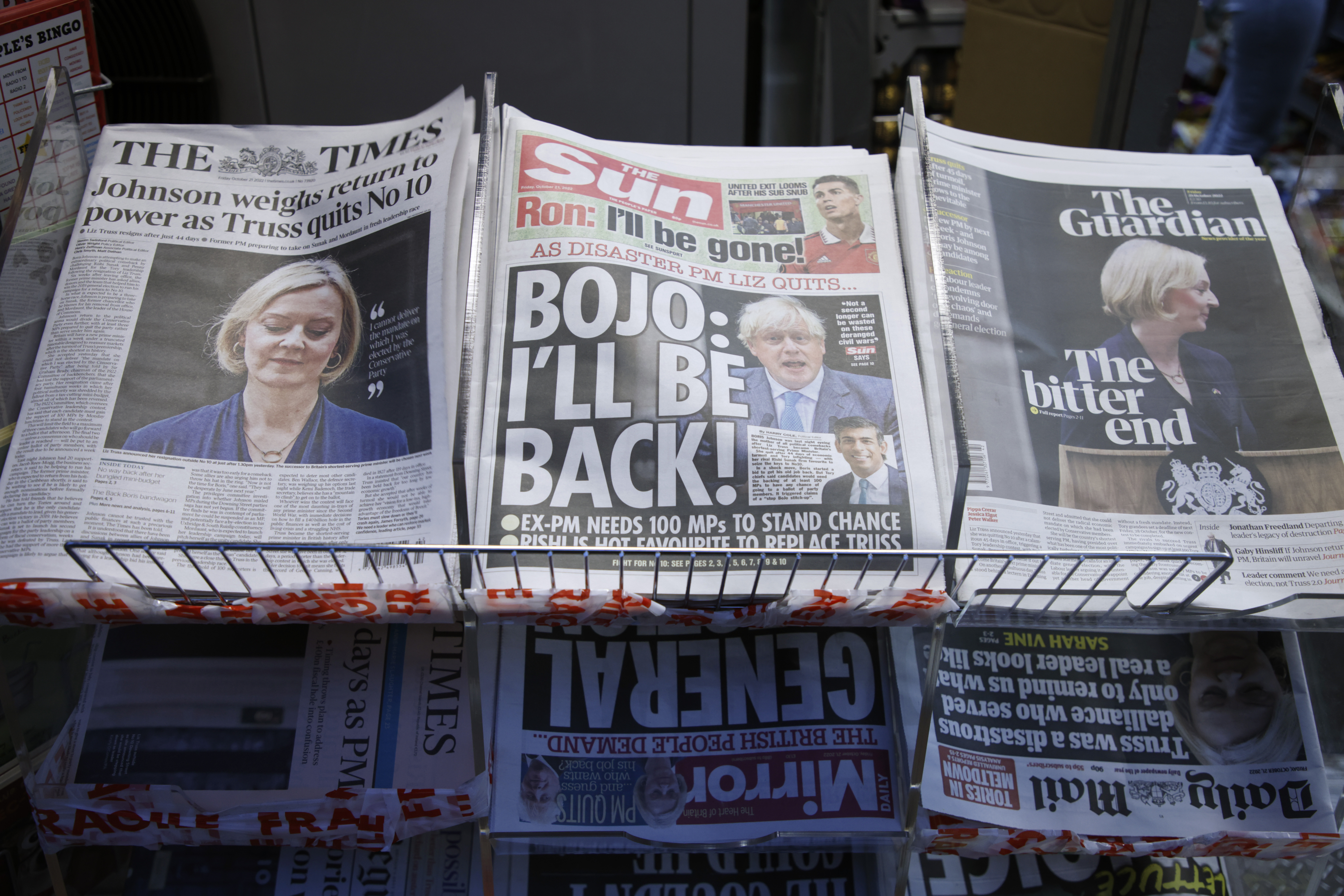 A selection of the front pages of British national newspapers showing the reaction the the resignation of Prime Minister Liz Truss, at a newsagents in central London, Friday. Several British lawmakers are jockeying for support to become the country's next leader following the implosion of Truss' short-lived government. One of them is scandal-tarnished former Prime Minister Boris Johnson.
