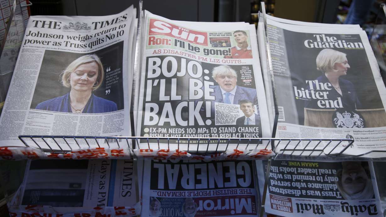 A selection of the front pages of British national newspapers showing the reaction the the resignation of Prime Minister Liz Truss, at a newsagents in central London, Friday. Several British lawmakers are jockeying for support to become the country's next leader following the implosion of Truss' short-lived government. One of them is scandal-tarnished former Prime Minister Boris Johnson.