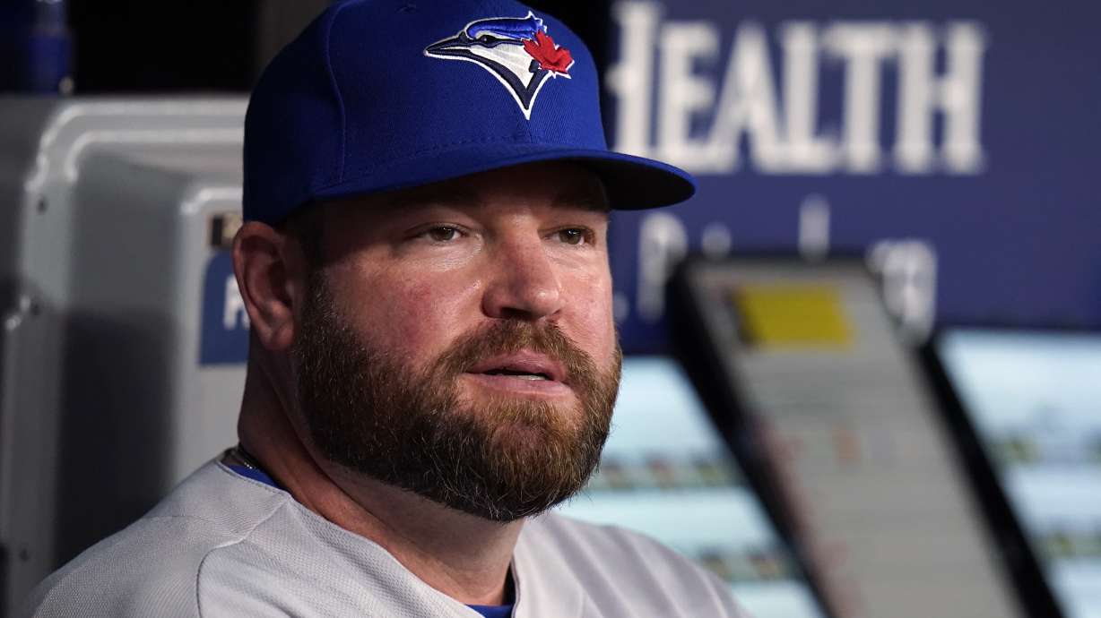 FILE - Toronto Blue Jays interim manager John Schneider looks on from the dugout during the first inning of a baseball game against the Tampa Bay Rays, Thursday, Sept. 22, 2022, in St. Petersburg, Fla. The Blue Jays rewarded Schneider for his strong performance as their interim manager, agreeing to terms with him Friday, Oct. 21, 2022, on a new contract. Schneider agreed to a three-year deal as manager with a team option for 2026, the Blue Jays said.