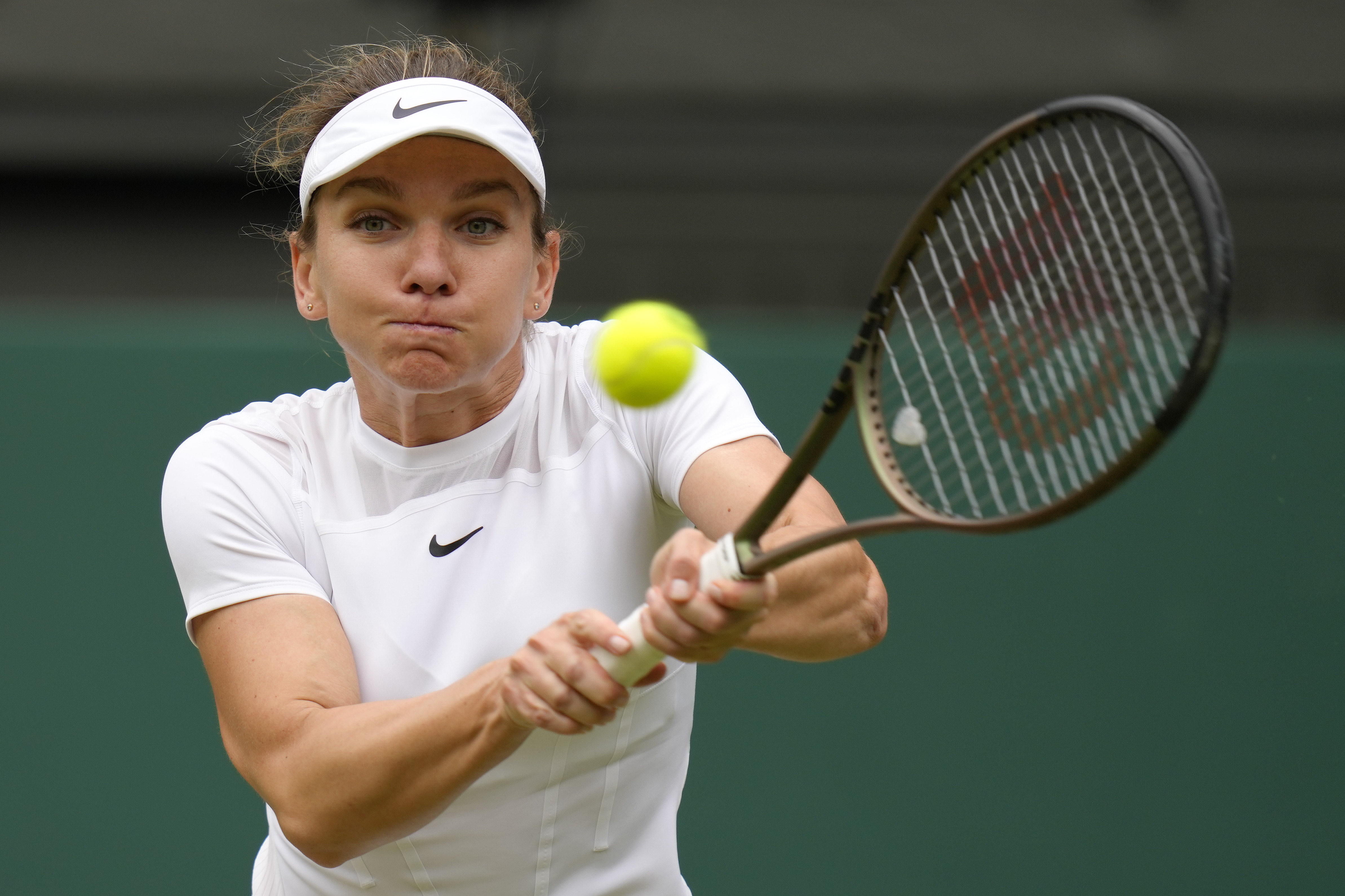 FILE - Romania's Simona Halep returns to Amanda Anisimova in a women's singles quarterfinal match on day ten of the Wimbledon tennis championships in London, Wednesday, July 6, 2022. Former No. 1-ranked player Simona Halep was provisionally suspended by the International Tennis Integrity Agency after failing a drug test during the U.S. Open last month. The ITIA announced the suspension Friday, Oct. 21, 2022, for Halep, a two-time Grand Slam champion who is currently No. 9 in the WTA rankings.