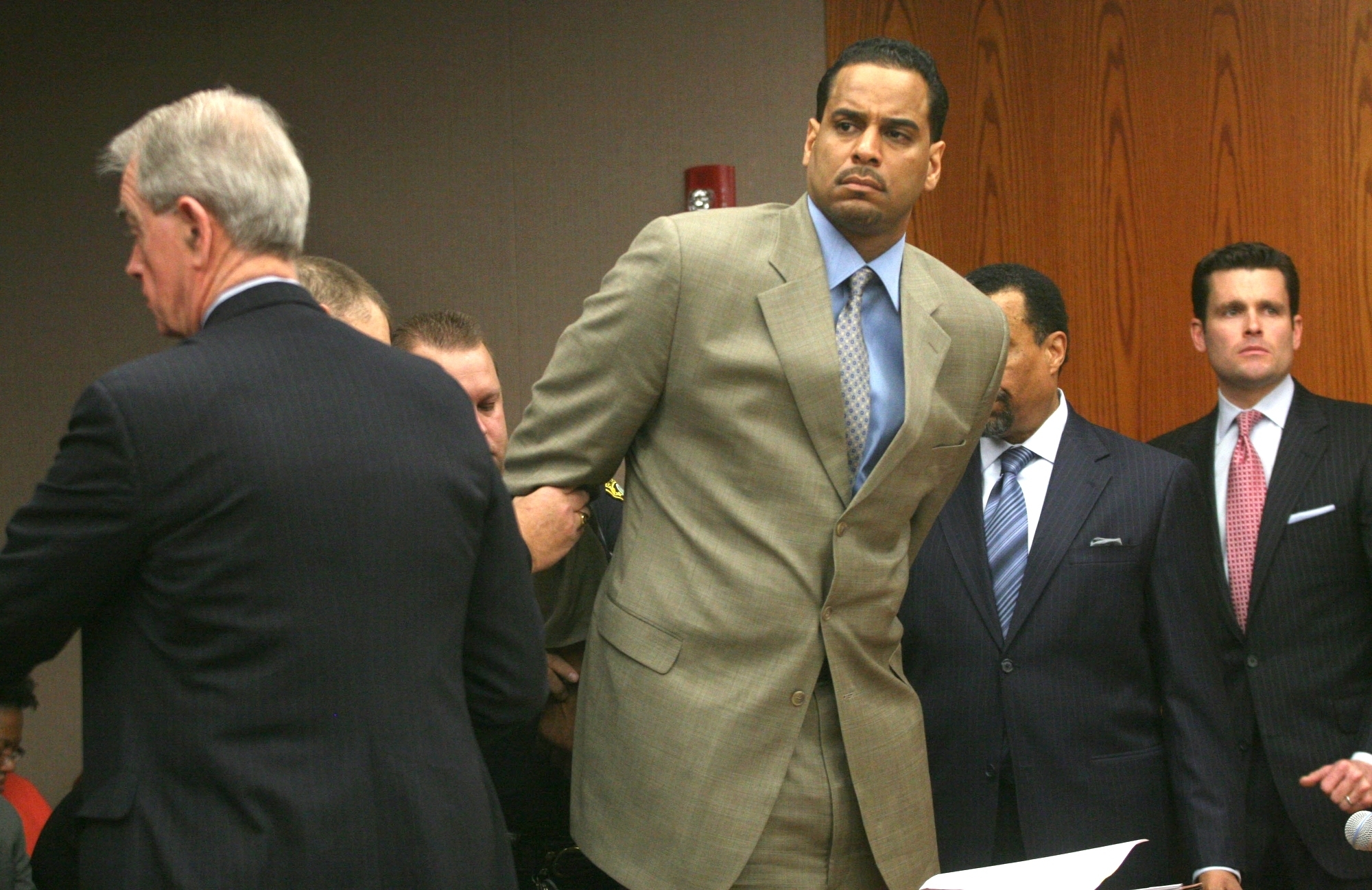 FILE - Jayson Williams is handcuffed after he was sentenced to five years in prison Tuesday Feb. 23, 2010, at State Superior Court , in Somerville, N.J., for fatally shooting a hired driver in 2002. The teenage daughters of former NBA All-Star Jayson Williams have denounced St. John’s University for its decision to induct their father into the school’s Athletics Hall of Fame. Tryumph and Whizdom Williams both wrote open letters they sent Friday, Oct. 21, 2022, to The Associated Press, and also planned to send to St. John’s, that said the school should be ashamed for his induction into the class during Saturday’s homecoming weekend. 