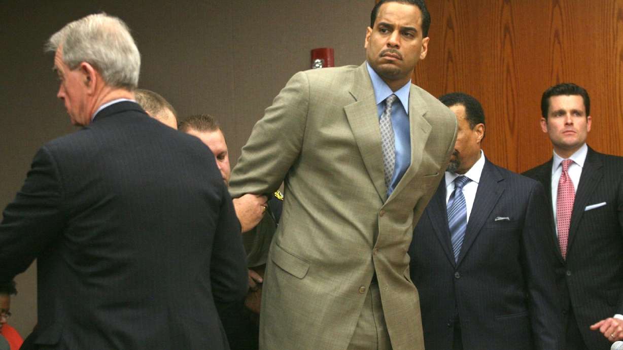 FILE - Jayson Williams is handcuffed after he was sentenced to five years in prison Tuesday Feb. 23, 2010, at State Superior Court , in Somerville, N.J., for fatally shooting a hired driver in 2002. The teenage daughters of former NBA All-Star Jayson Williams have denounced St. John’s University for its decision to induct their father into the school’s Athletics Hall of Fame. Tryumph and Whizdom Williams both wrote open letters they sent Friday, Oct. 21, 2022, to The Associated Press, and also planned to send to St. John’s, that said the school should be ashamed for his induction into the class during Saturday’s homecoming weekend.