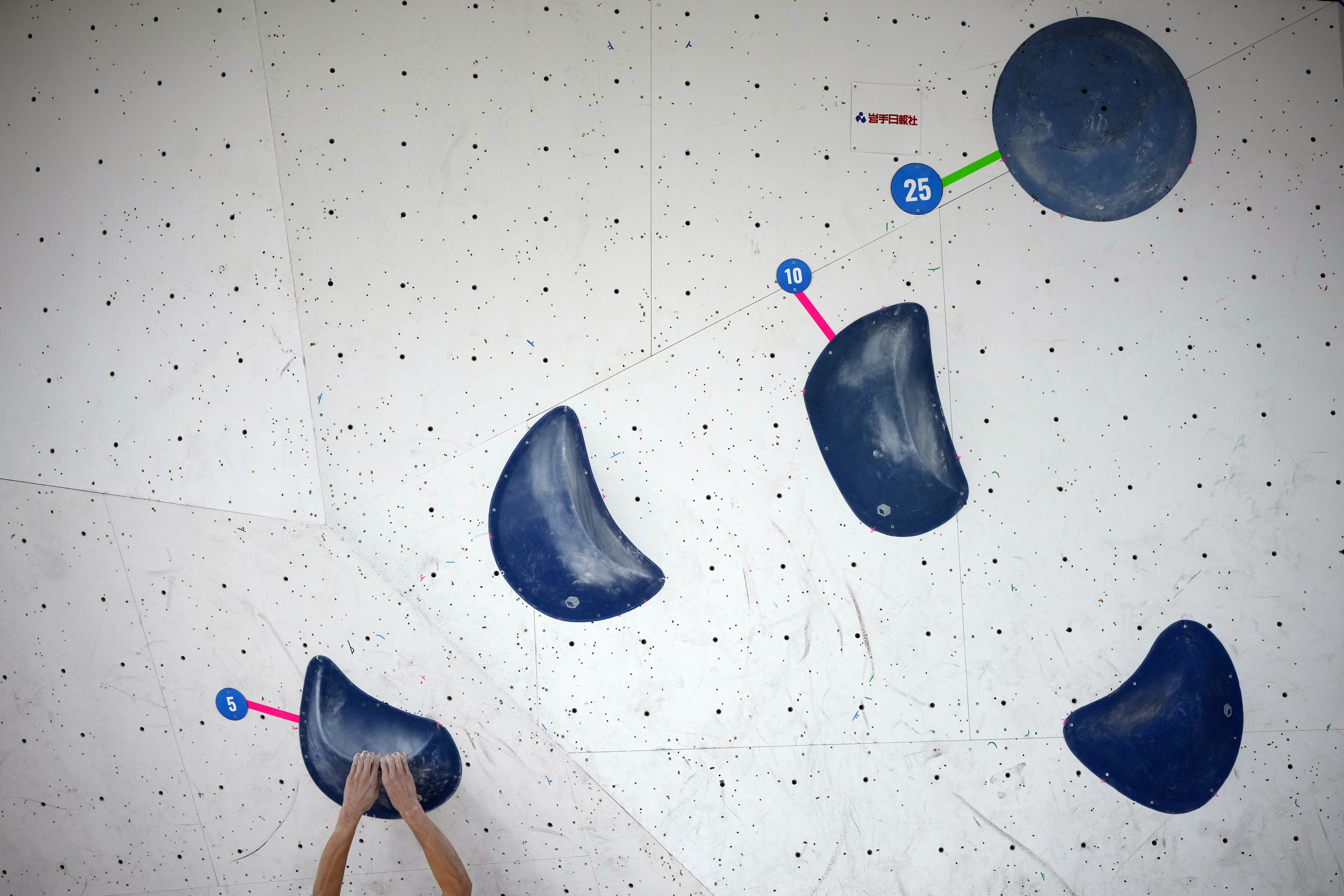An athlete competes during the boulder semi-final of the IFSC Climbing World Cup Friday, Oct. 21, 2022, in Morioka, Iwate Prefecture, Japan. After Iranian climber Elnaz Rekabi joined a growing list of female athletes who have been targeted by their governments for defying authoritarian policies or acting out against bullying, a number of others have spoken out on their concerns of politics crossing into their sporting world. 