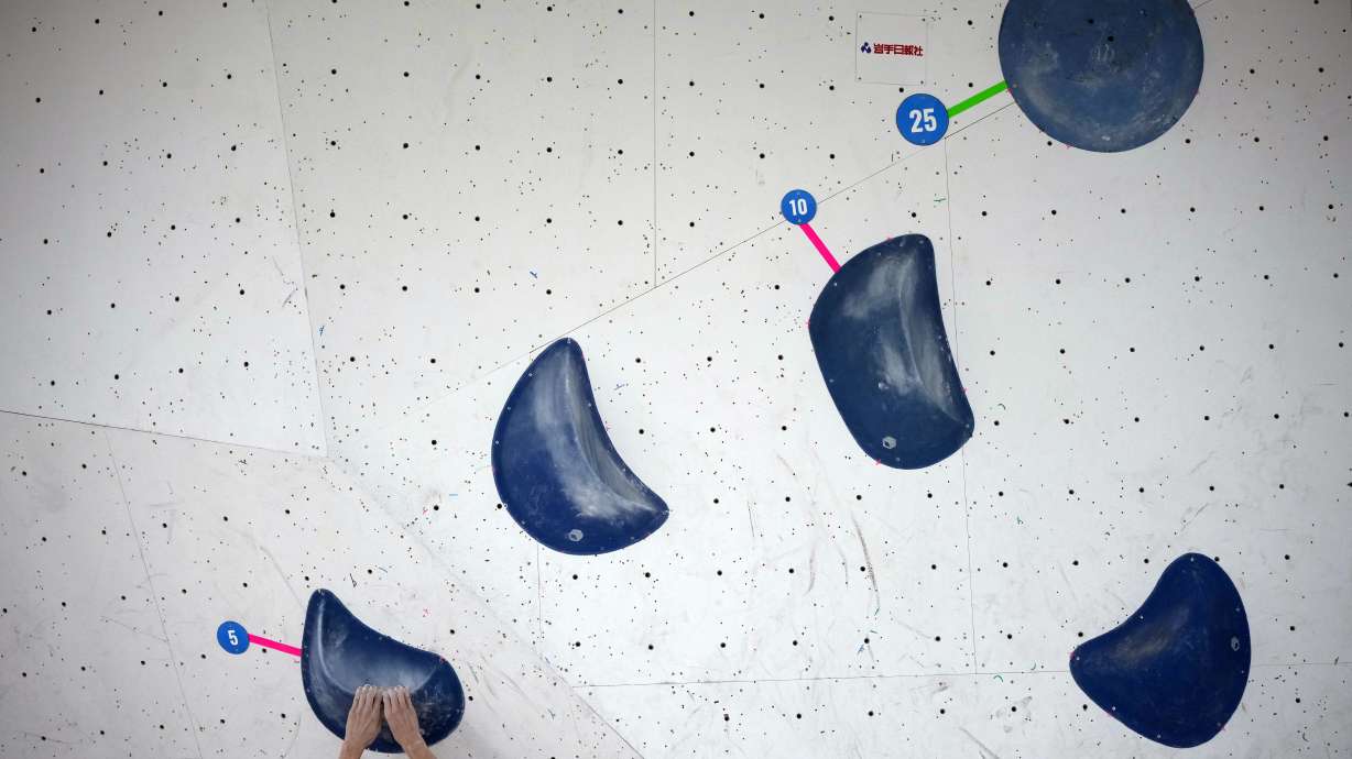 An athlete competes during the boulder semi-final of the IFSC Climbing World Cup Friday, Oct. 21, 2022, in Morioka, Iwate Prefecture, Japan. After Iranian climber Elnaz Rekabi joined a growing list of female athletes who have been targeted by their governments for defying authoritarian policies or acting out against bullying, a number of others have spoken out on their concerns of politics crossing into their sporting world.