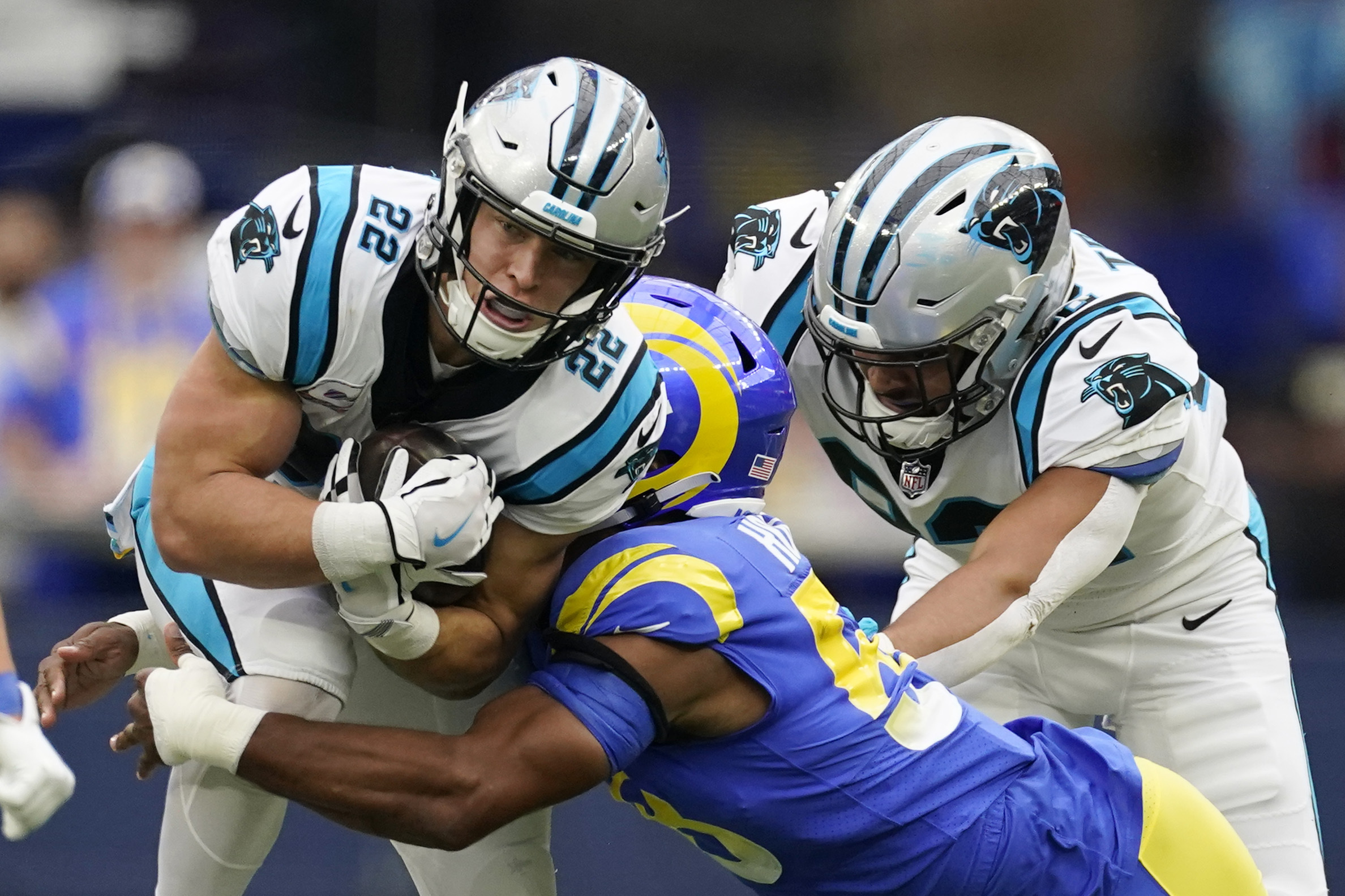 Carolina Panthers running back Christian McCaffrey, left, is tackled by Los Angeles Rams linebacker Justin Hollins during the first half of an NFL football game Sunday, Oct. 16, 2022, in Inglewood, Calif.