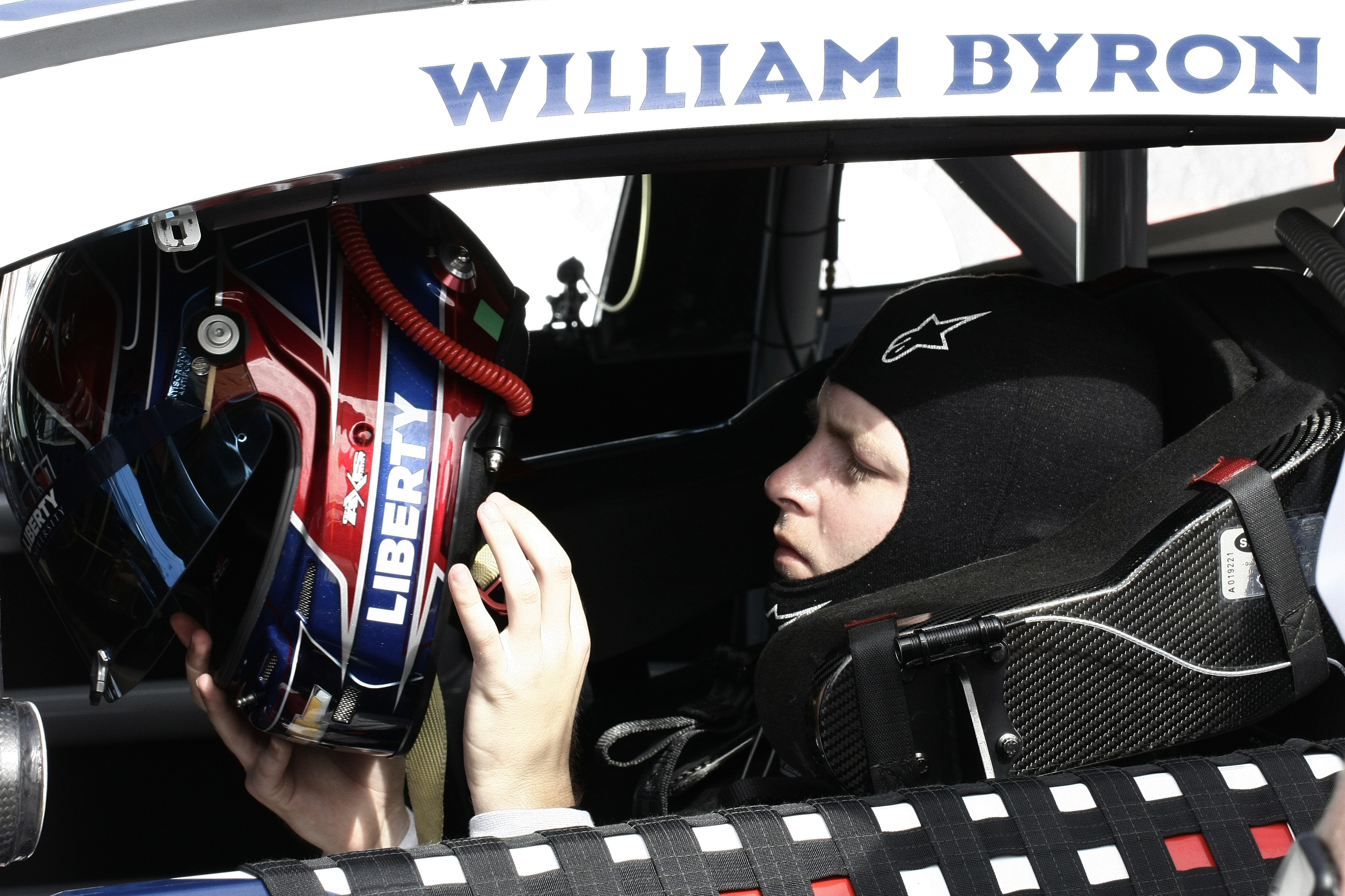 William Byron puts on his helmet during NASCAR cup series qualifying at Homestead-Miami Speedway, Saturday, Oct. 22, 2022, in Homestead, Fla.