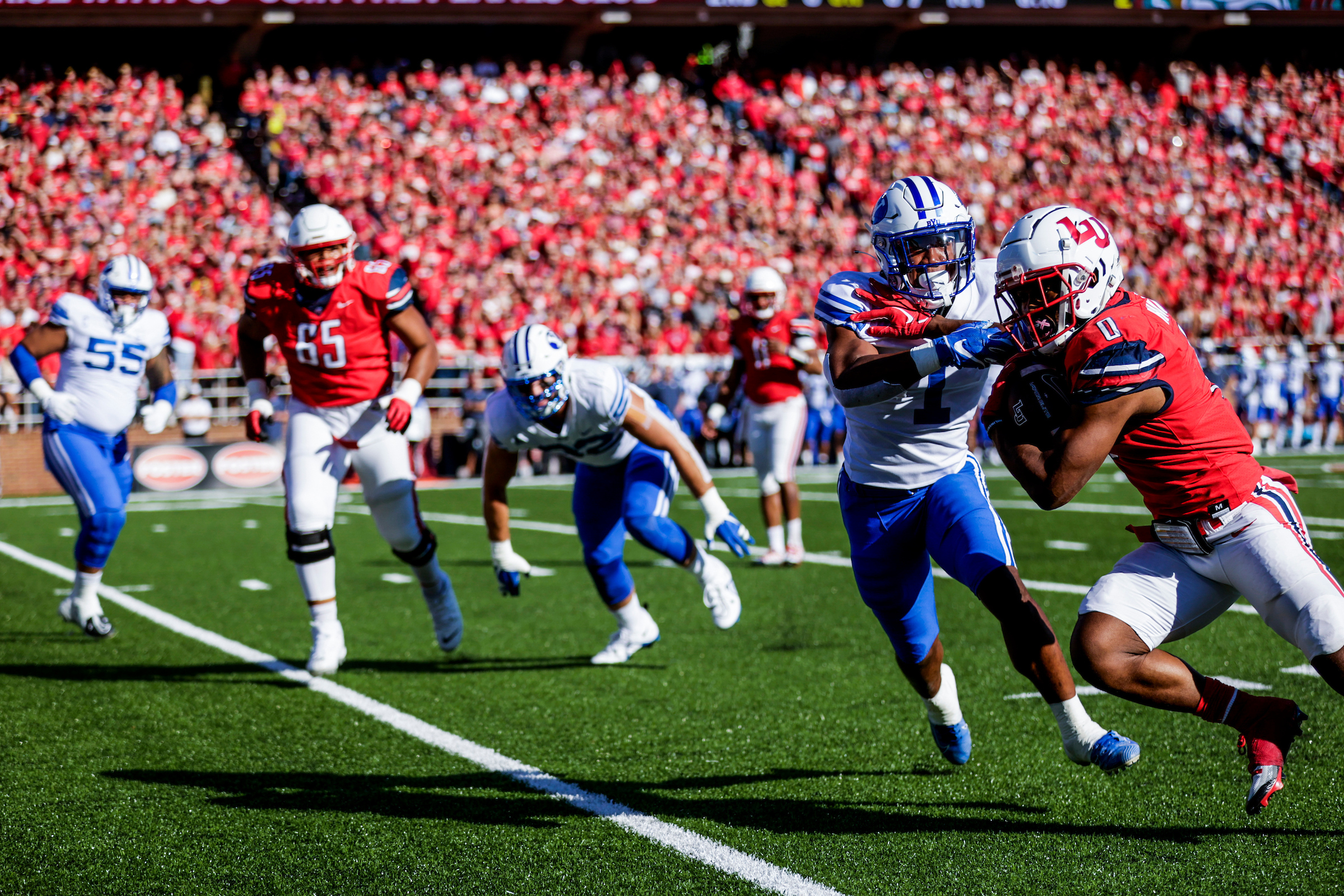 BYU tries to stop Liberty's rushing attack, Saturday, Oct. 22, 2022 at Williams Stadium in Lynchburg, Virginia.
