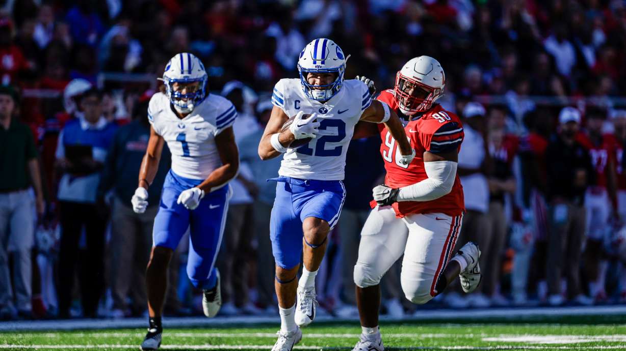 Puka Nacua runs for a touchdown during the Cougars' football game against Liberty, Saturday, Oct. 22, 2022 in Lynchburg, Virginia.