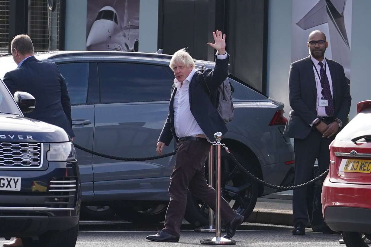 Former Prime Minister Boris Johnson arrives at Gatwick Airport in London, after traveling on a flight from the Caribbean, following the resignation of Liz Truss as Prime Minister, Saturday.