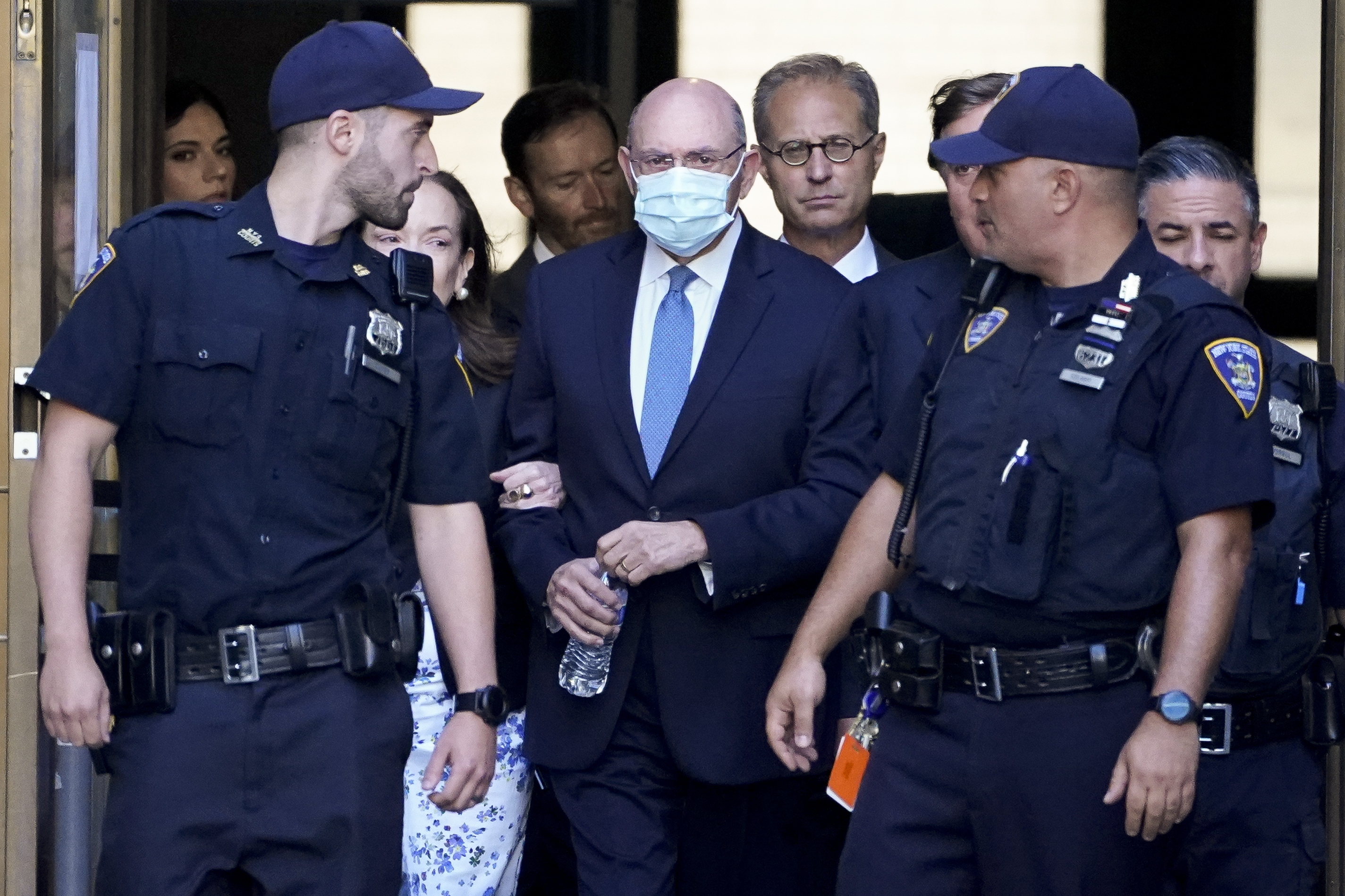 Trump Organization's former Chief Financial Officer Allen Weisselberg, center, leaves court Aug. 18, in New York. The Trump Organization is going on trial accused of helping some top executives avoid income taxes on compensation they got in addition to their salaries.