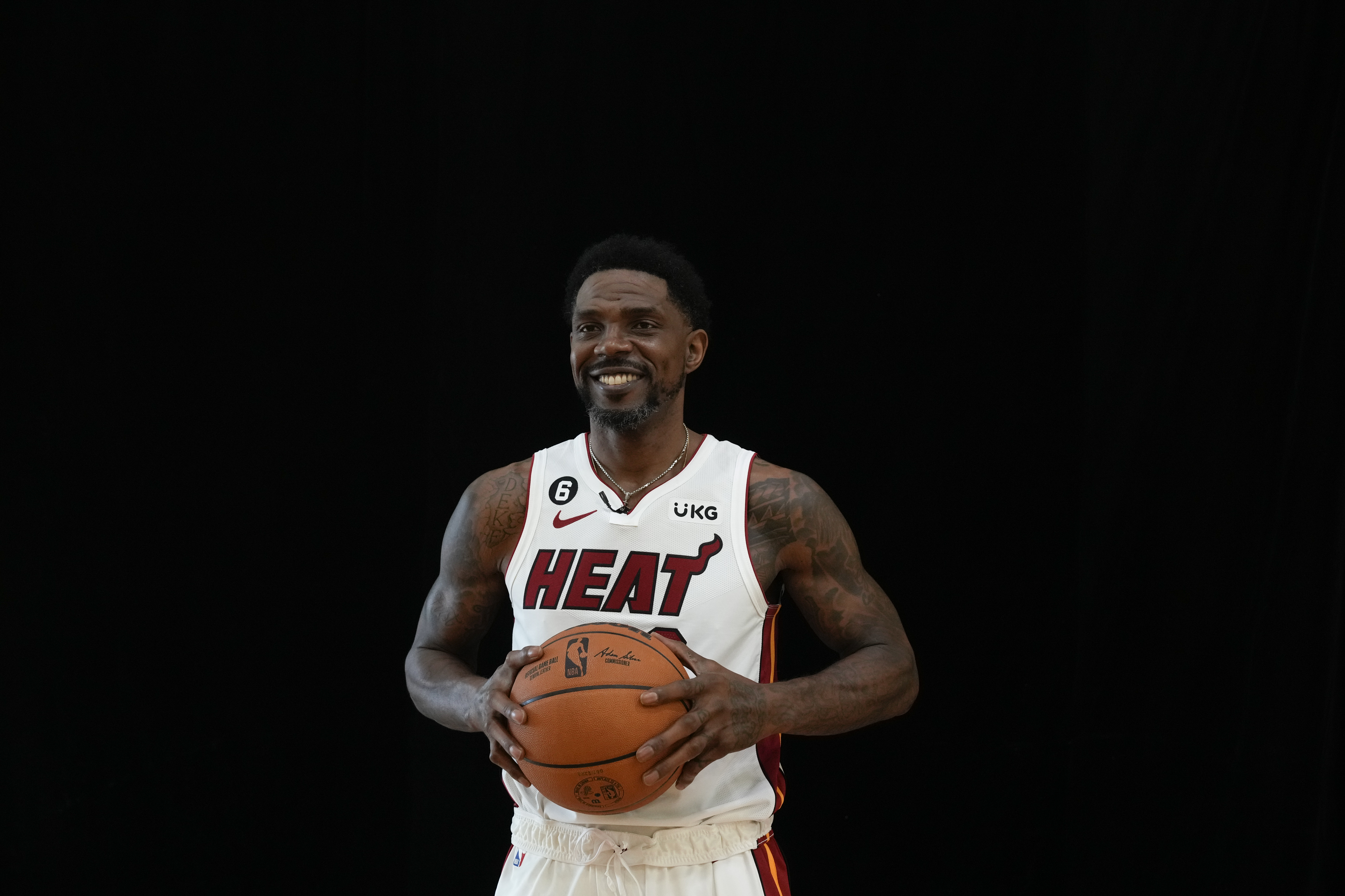 Miami Heat's Udonis Haslem walks in front of a black backdrop, during a portrait session at the NBA basketball team's Media Day in Miami, Monday, Sept. 26, 2022. 