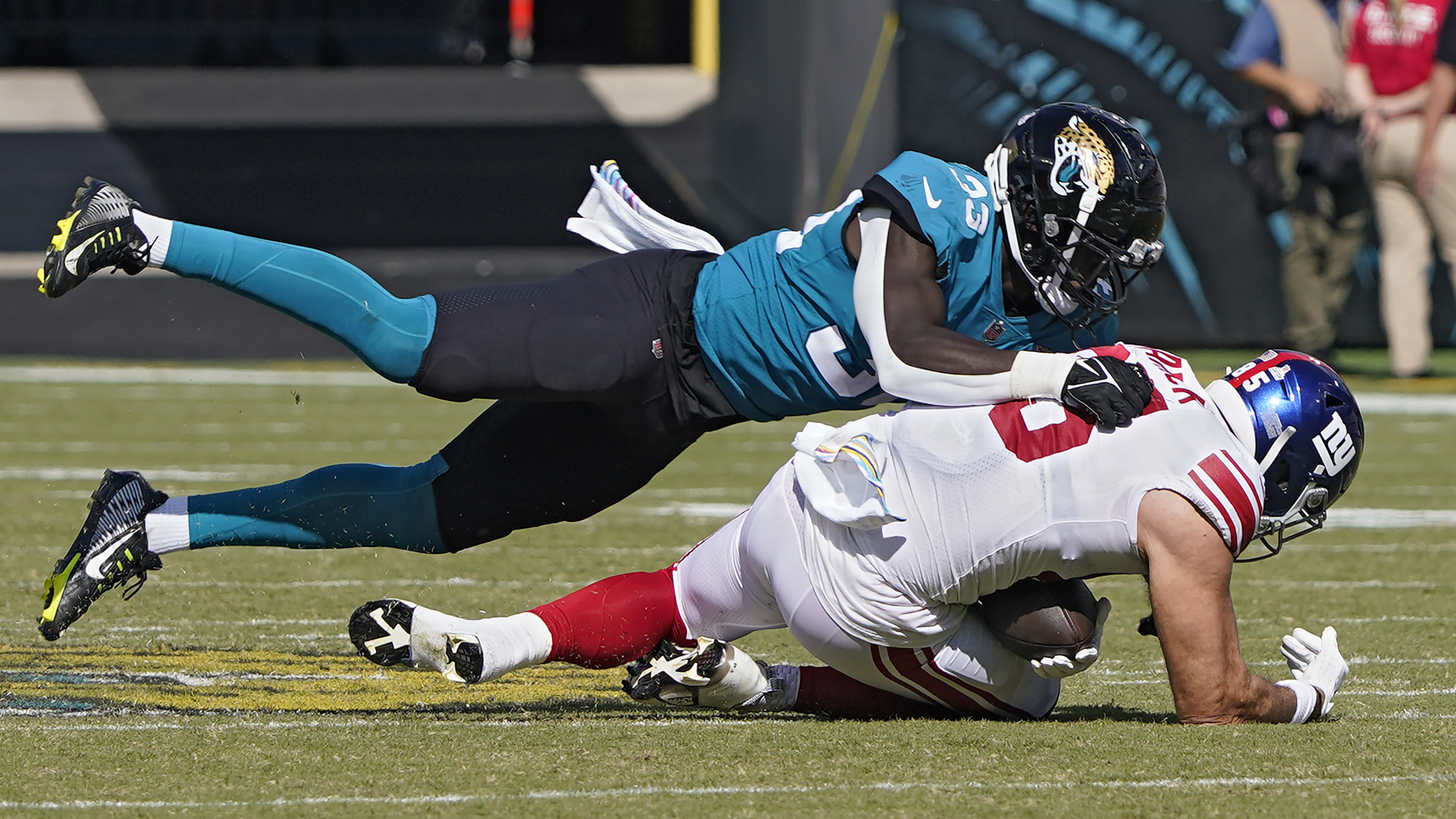 Jacksonville Jaguars linebacker Devin Lloyd (33) sacks New York Giants quarterback Daniel Jones (8) during the second half of an NFL football game Sunday, Oct. 23, 2022, in Jacksonville, Fla.