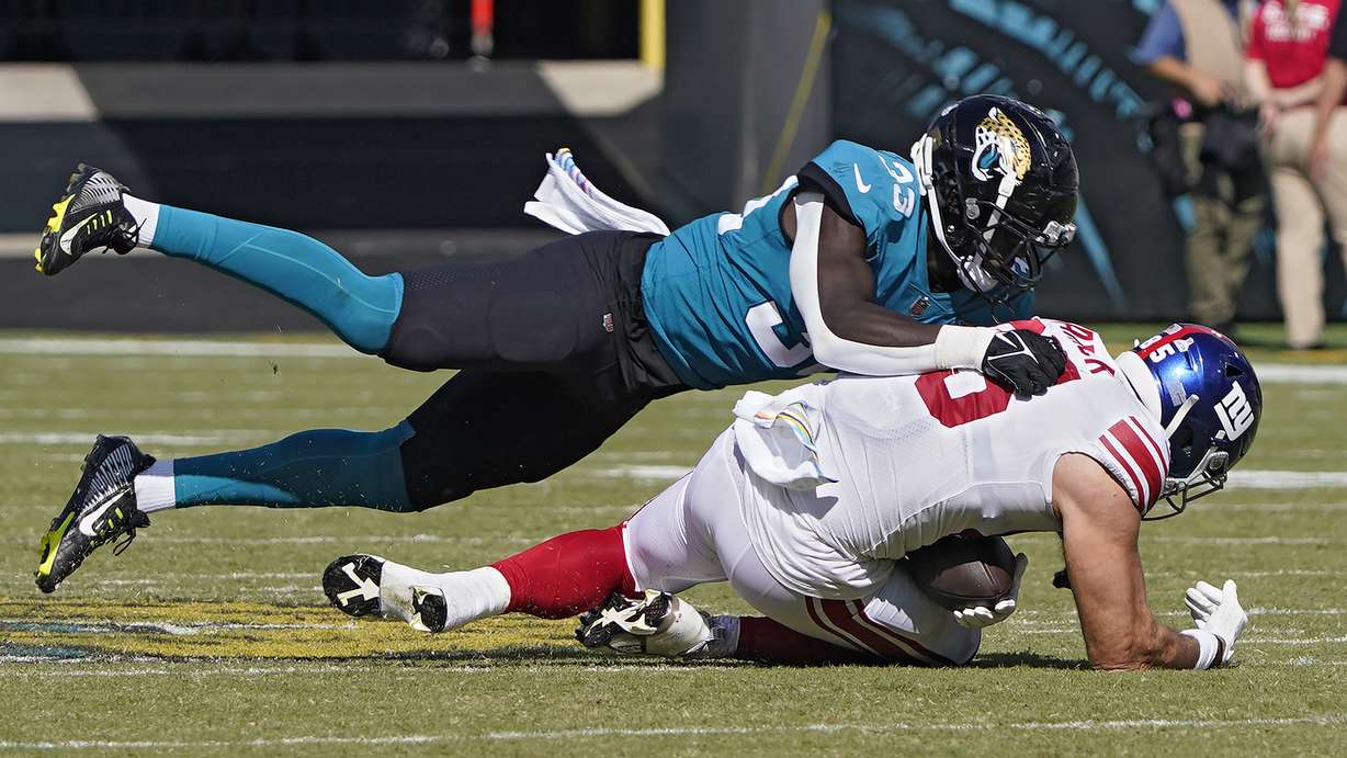 Jacksonville Jaguars linebacker Devin Lloyd (33) sacks New York Giants quarterback Daniel Jones (8) during the second half of an NFL football game Sunday, Oct. 23, 2022, in Jacksonville, Fla.