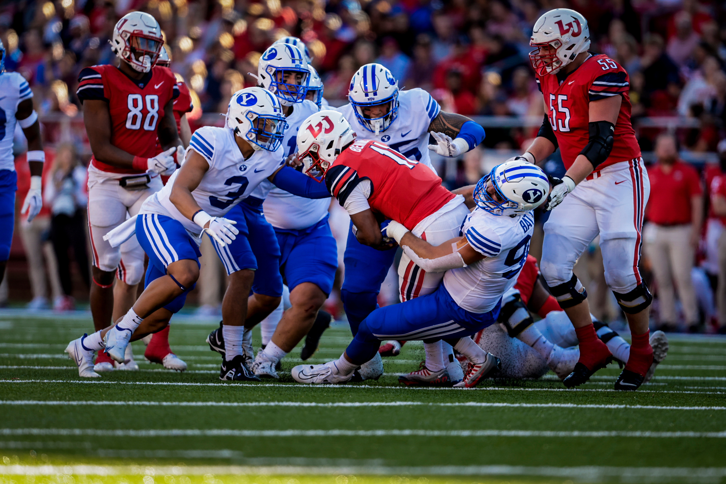 BYU defensive end Tyler Batty makes a tackle against Liberty,, Saturday, Oct. 22, 2022 in Lynchburg, Virginia.