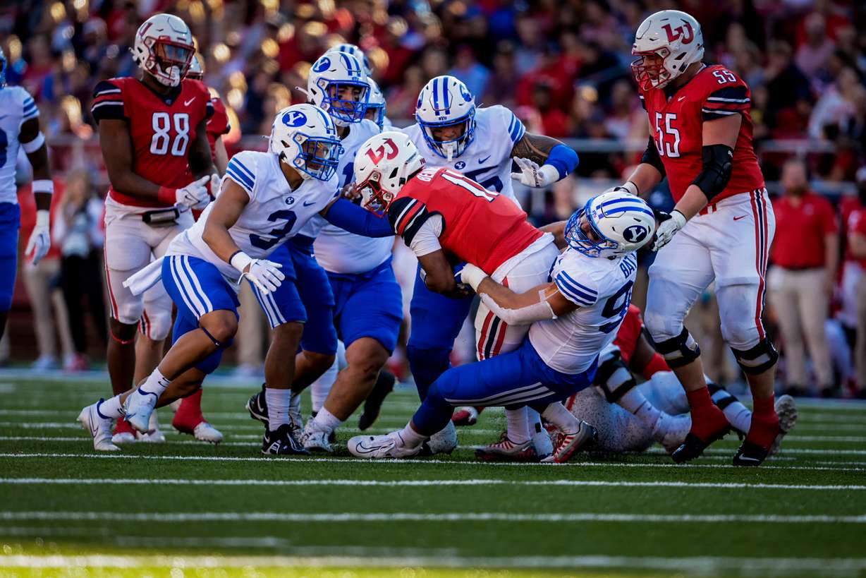 BYU defensive end Tyler Batty makes a tackle against Liberty,, Saturday, Oct. 22, 2022 in Lynchburg, Virginia.
