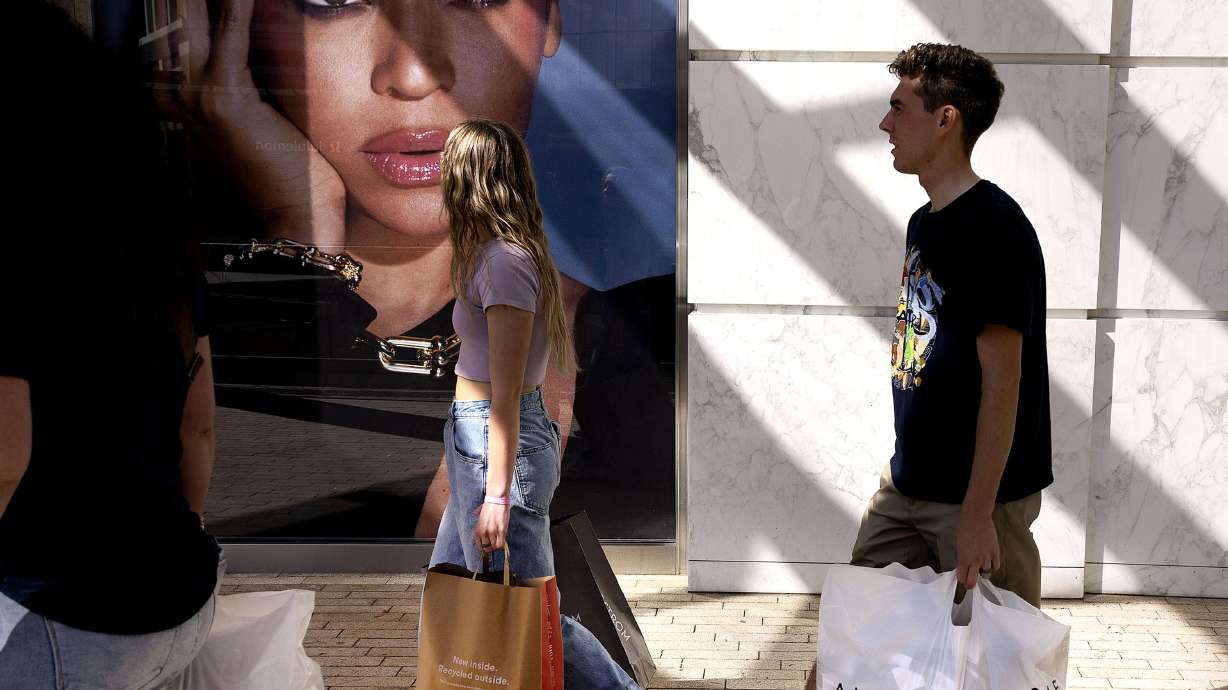 Michelle Bishop, left, and her children, Londyn and Logan, shop at City Creek Center in Salt Lake City on Thursday. Results from a new Deseret News/Hinckley Institute of Politics poll finds most Utahns are planning on spending about the same or more on holiday gifts as they did last year, even as most are also concerned about inflation and the potential for a looming recession.