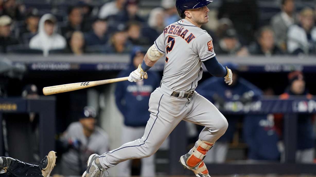 Houston Astros Alex Bregman (2) follows through on a base hit to drive in a run against the New York Yankees during the seventh inning of Game 4 of an American League Championship baseball series, Sunday, Oct. 23, 2022, in New York.