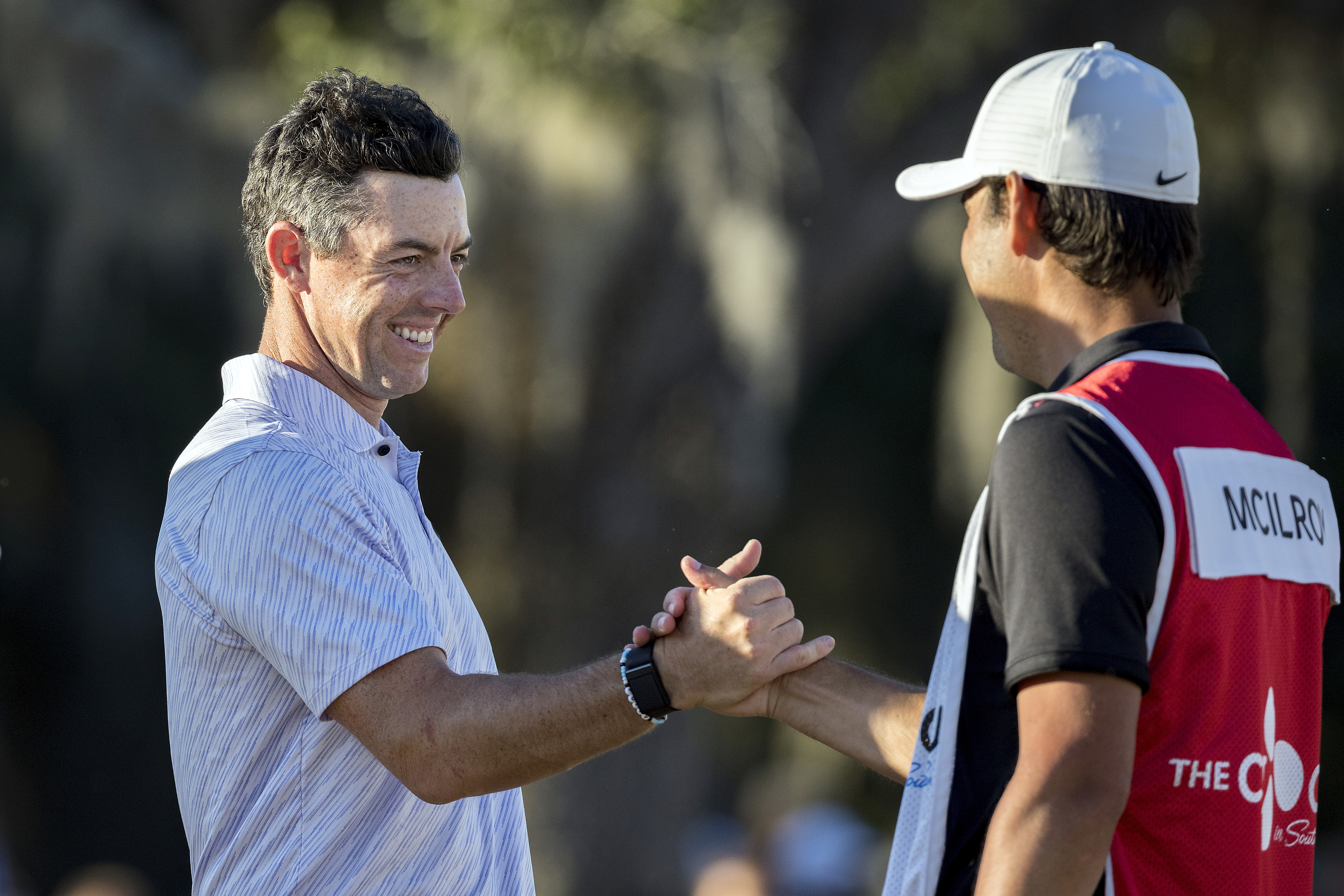 Rory McIlroy, left, of Northern Ireland, left, celebrates with his caddie after the final round of the CJ Cup golf tournament Sunday, Oct. 23, 2022, in Ridgeland, S.C. 