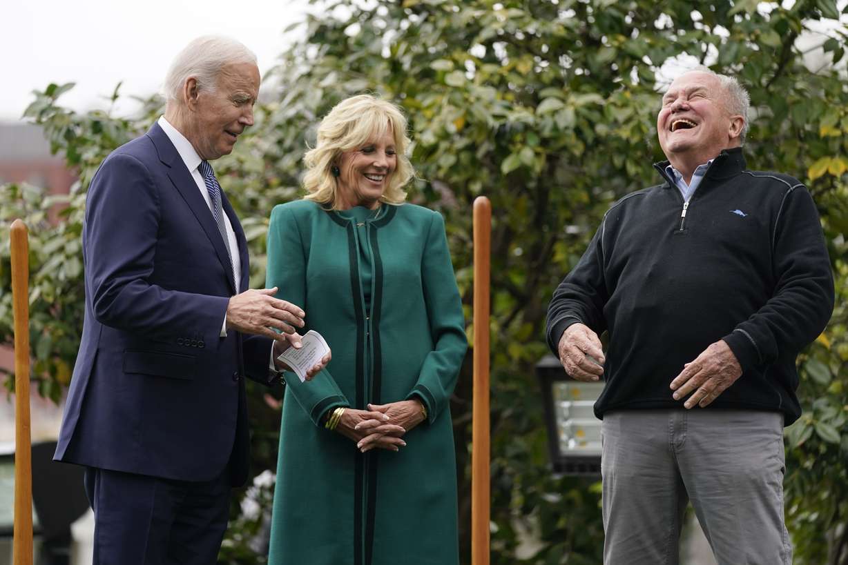 Dale Haney, the chief White House groundskeeper, right, laughs as he stands with President Joe Biden and first lady Jill Biden during a tree planting ceremony on the South Lawn of the White House on Monday in Washington. As of this month, Haney has tended the lawns and gardens of the White House for 50 years.