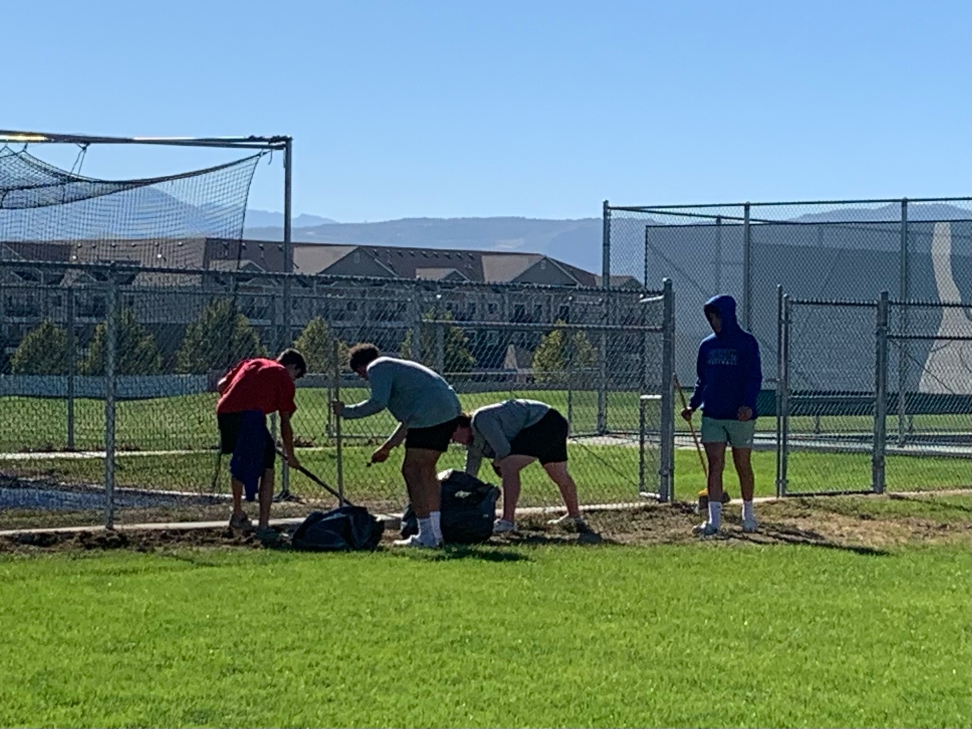 Bingham football players perform yard work to give back to their community.