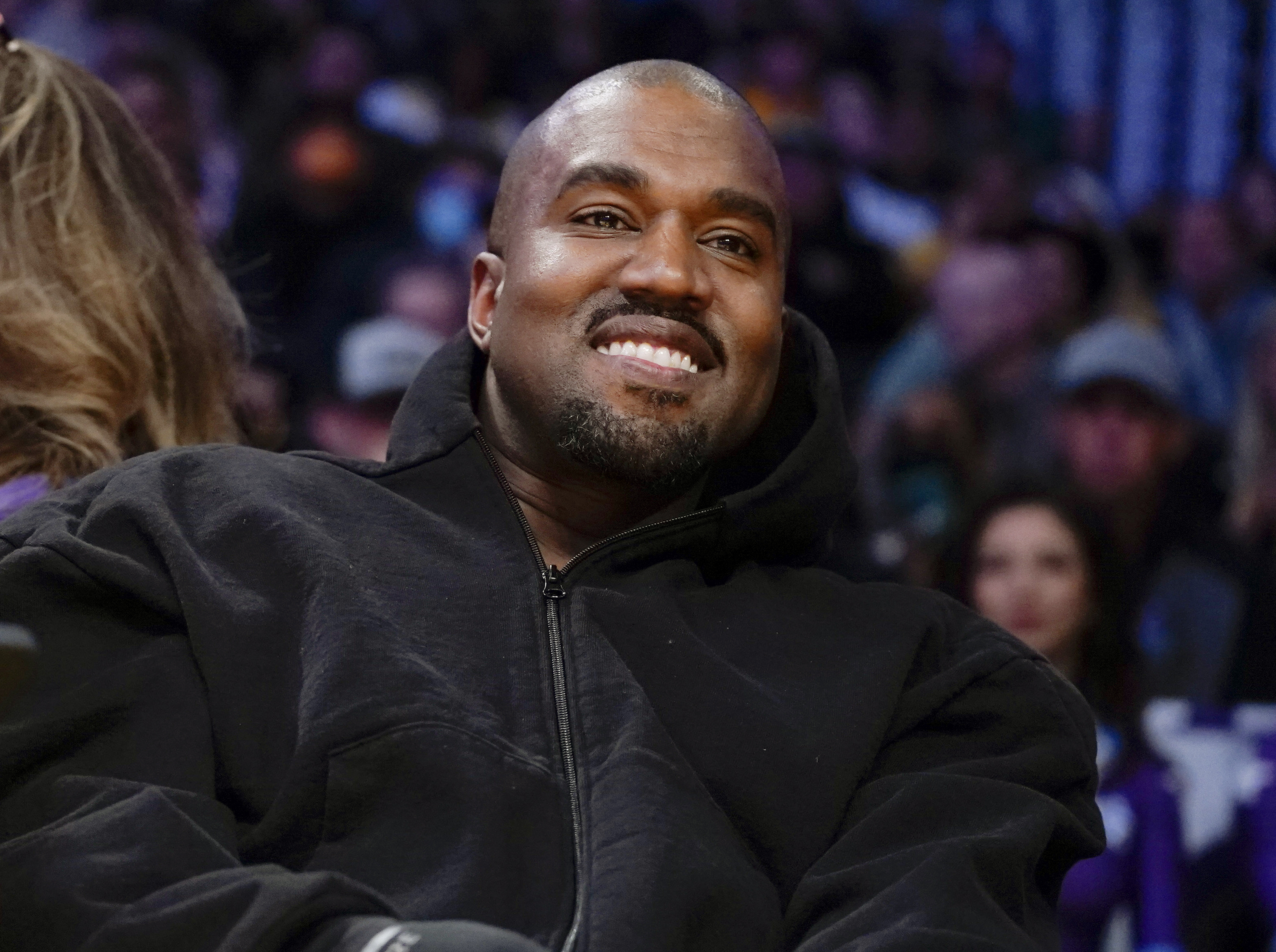 Kanye West watches the first half of an NBA basketball game between the Washington Wizards and the Los Angeles Lakers in Los Angeles, on March 11. Adidas has ended its partnership with the rapper formerly known as Kanye West over his offensive and antisemitic remarks. 