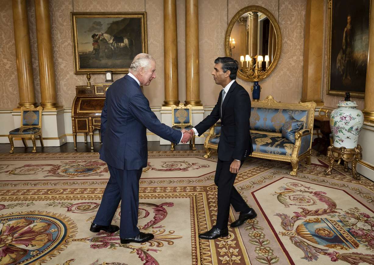 King Charles III welcomes Rishi Sunak during an audience at Buckingham Palace, London, where he invited the newly elected leader of the Conservative Party to become Prime Minister and form a new government, Tuesday, Oct. 25.