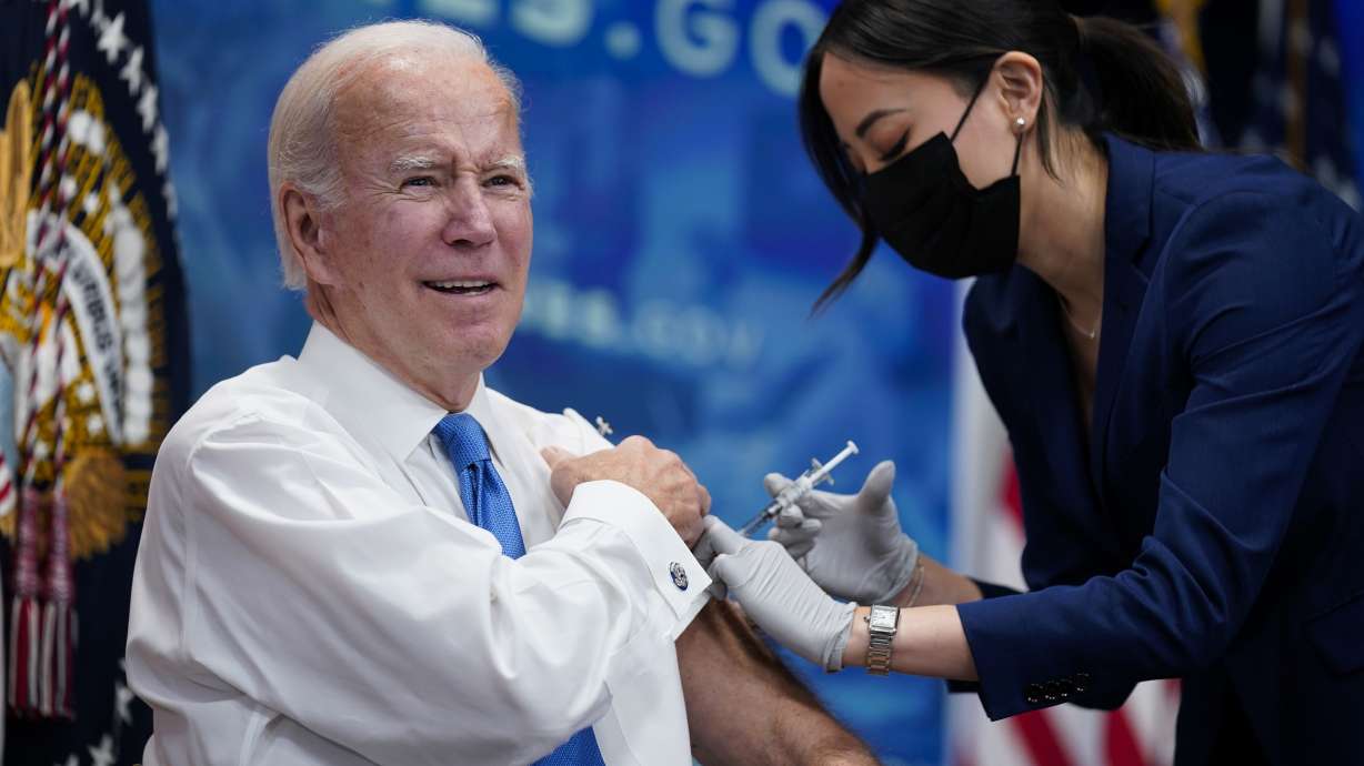 President Joe Biden receives his COVID-19 booster from a member of the White House medical unit during an event in the South Court Auditorium on the White House campus, Tuesday in Washington.