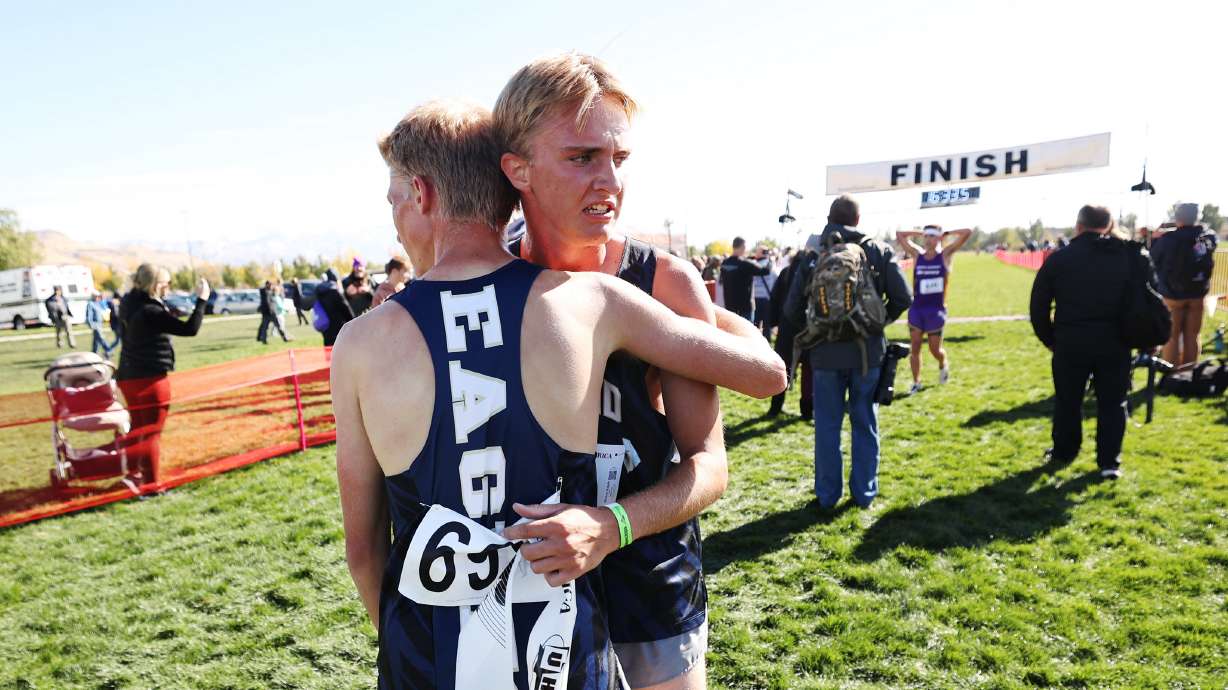 Brothers Ben, left, and Michael Ralphs, right, hug after finishing in second and first place, respectively, in the boys 2A race.