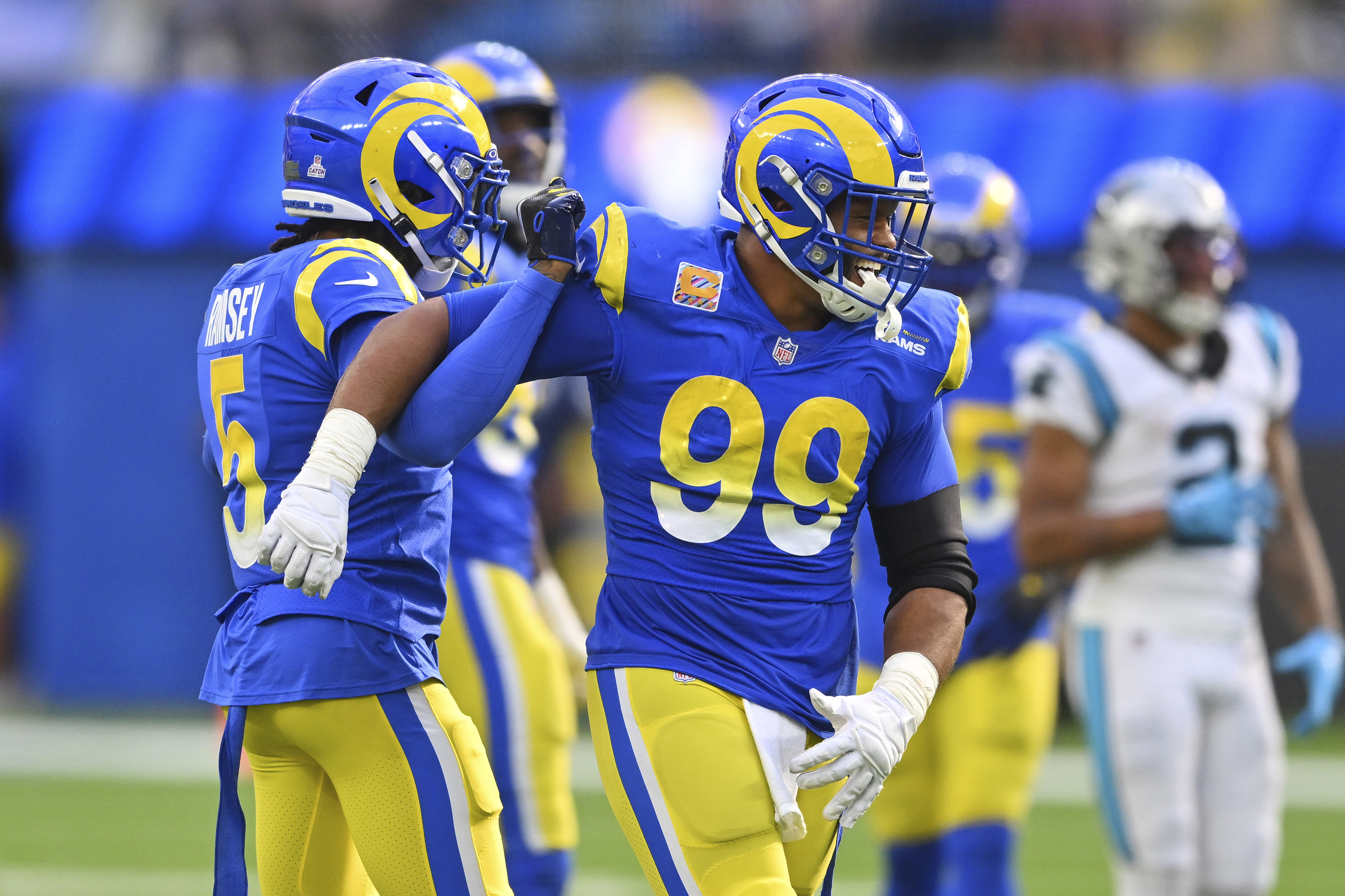 Los Angeles Rams cornerback Jalen Ramsey left, celebrates his sack on Carolina Panthers quarterback PJ Walker with defensive tackle Aaron Donald (99) during the second half of an NFL football game Sunday, Oct. 16, 2022, in Inglewood, Calif. 