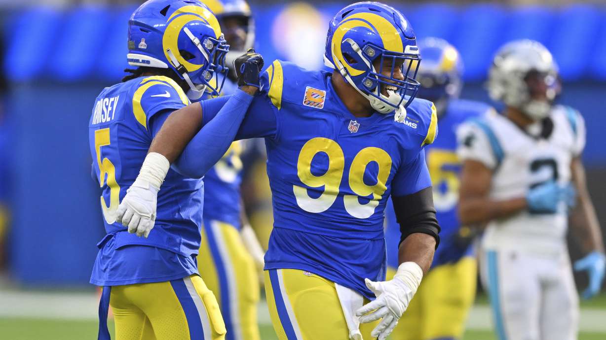 Los Angeles Rams cornerback Jalen Ramsey left, celebrates his sack on Carolina Panthers quarterback PJ Walker with defensive tackle Aaron Donald (99) during the second half of an NFL football game Sunday, Oct. 16, 2022, in Inglewood, Calif.