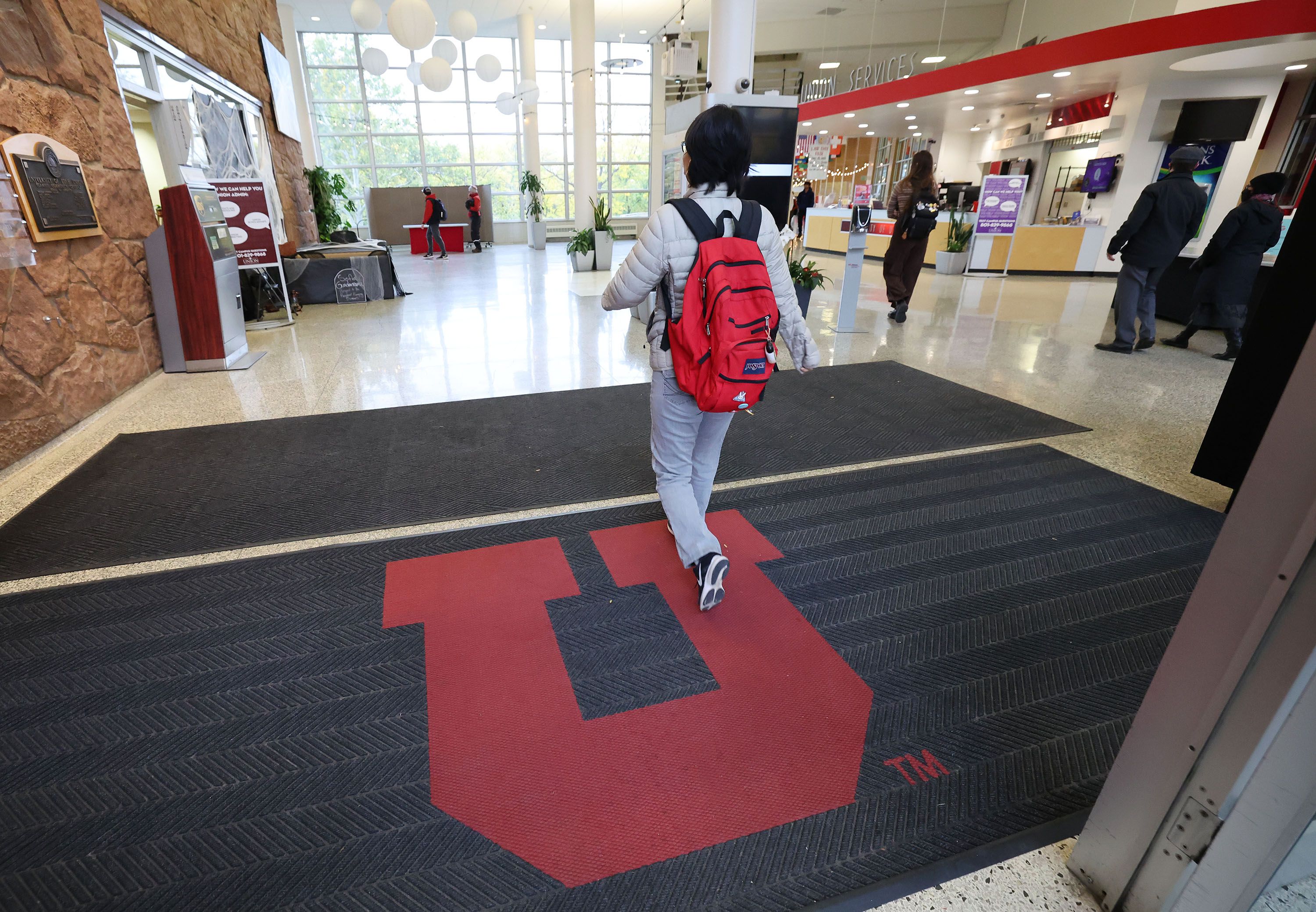 University of Utah students walk into the Union Building on campus in Salt Lake City on Tuesday. Utah Gov. Spencer Cox is talking about an across-the-board tuition freeze.