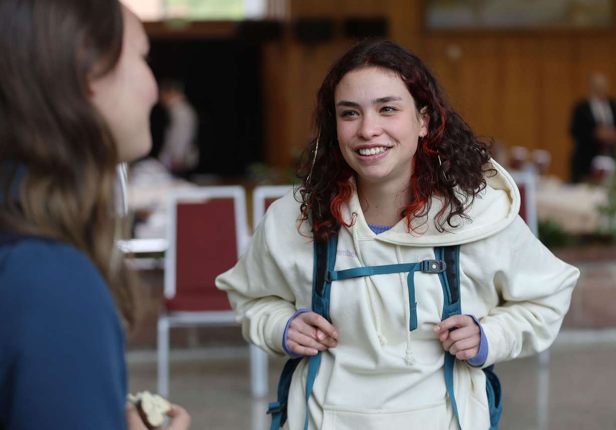 University of Utah student Alexis Friedman talks with another student on campus in Salt Lake City on Tuesday. Utah Gov. Spencer Cox is talking about an across-the-board tuition freeze.