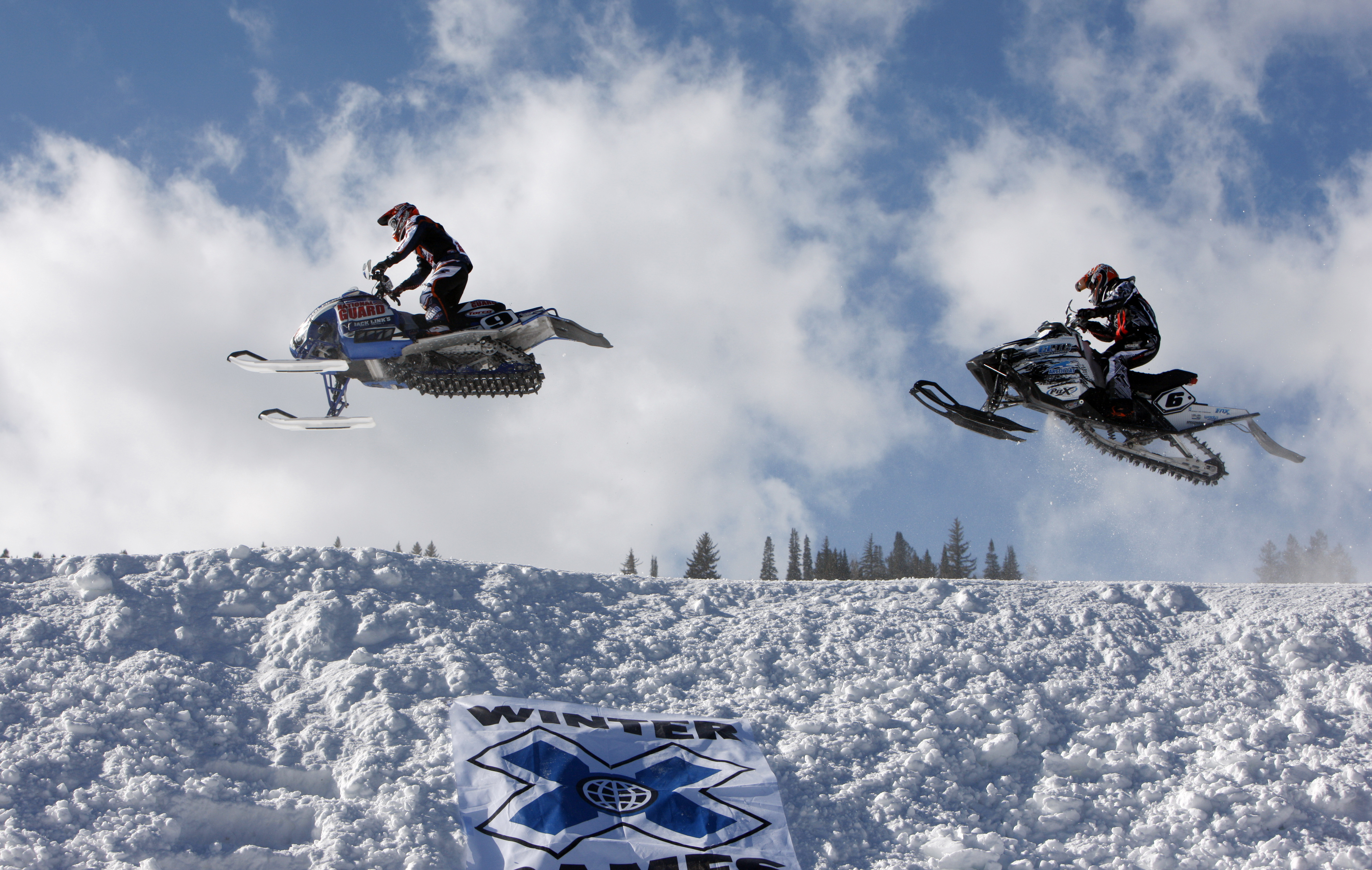 FILE - In this Jan. 31, 2010, file photo, Colby Crapo, left, leads Carl Schubitzke over a jump during a heat to determine placement in the snowmobile snocross final at the Winter X Games at Buttermilk Mountain outside Aspen, Colo. ESPN sold its majority stake in the X and Winter X Games on Wednesday, Oct. 26, 2022 marking the end of a nearly three-decade chapter during which the network helped propel snowboarding, skateboarding and other action sports out of the fringe and into the mainstream. 