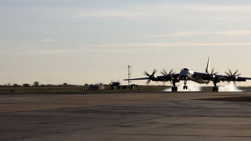 A still image from video, released by the Russian Defence Ministry, shows what it said to be Russia's Tu-95MS strategic bomber landing during exercises held by the country's strategic nuclear forces at an unknown location, in this image taken from handout footage released October 26, 2022.