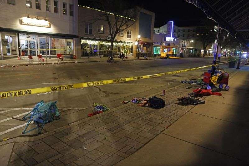Police tape cordons off a street in Waukesha, Wis., after an SUV plowed into a Christmas parade hitting multiple people Nov. 21, 2021.