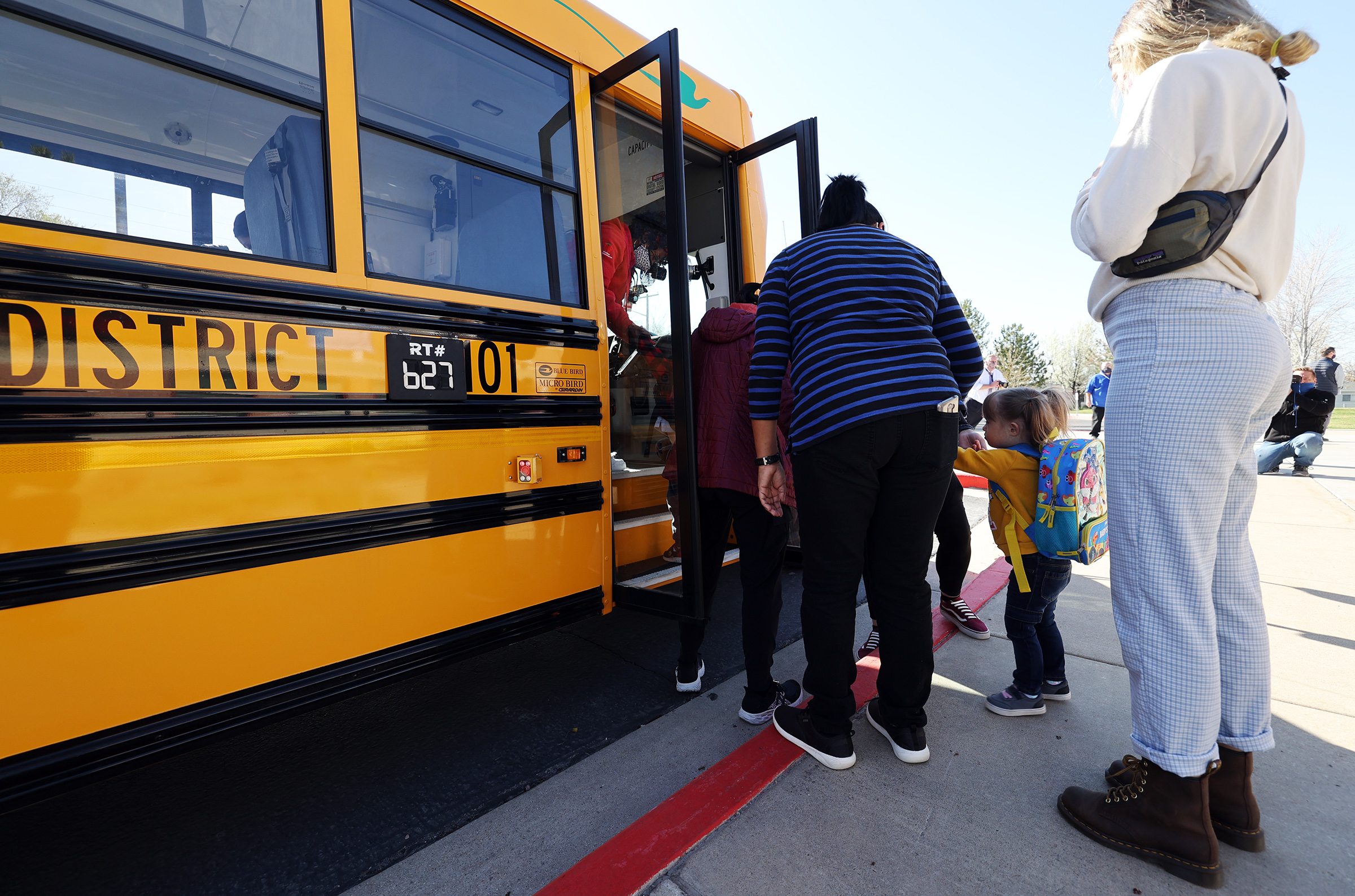 Teachers help students onto a new electric school bus at Parkview Elementary School in Salt Lake City on April 12, 2021. If the streets of Vernal and the Eureka area soon begin to seem quieter than usual — and if the air seems cleaner — it's probably because of a new fleet of electric school buses that will be transporting students to and from school in the near future.