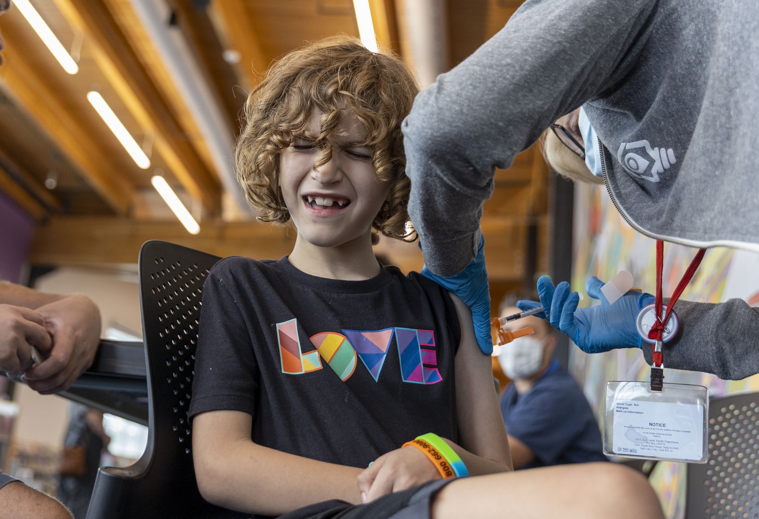 Nurse Cathy Martin administers a COVID-19 booster shot to Benson Park, 8, at the Kearns Library in Kearns on Sept. 29. Although COVID-19 vaccines have been put on the list of routine immunizations recommended for both children and adults by the Centers for Disease Control and Prevention, health experts stress that doesn't mean the shots are now mandatory.