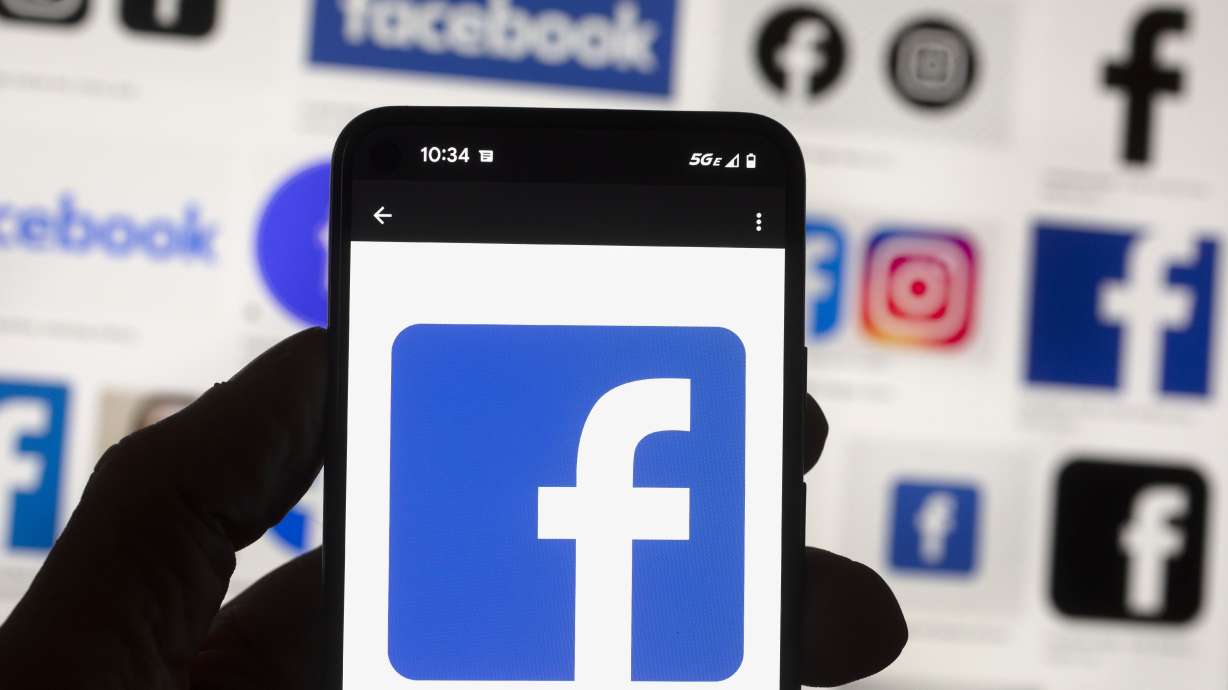 The Facebook logo is seen on a cell phone on Oct. 14 in Boston. A Washington state judge on Wednesday fined Facebook parent company Meta nearly $25 million for repeatedly and intentionally violating campaign finance disclosure law, in what is believed to be the largest campaign finance penalty in U.S. history.