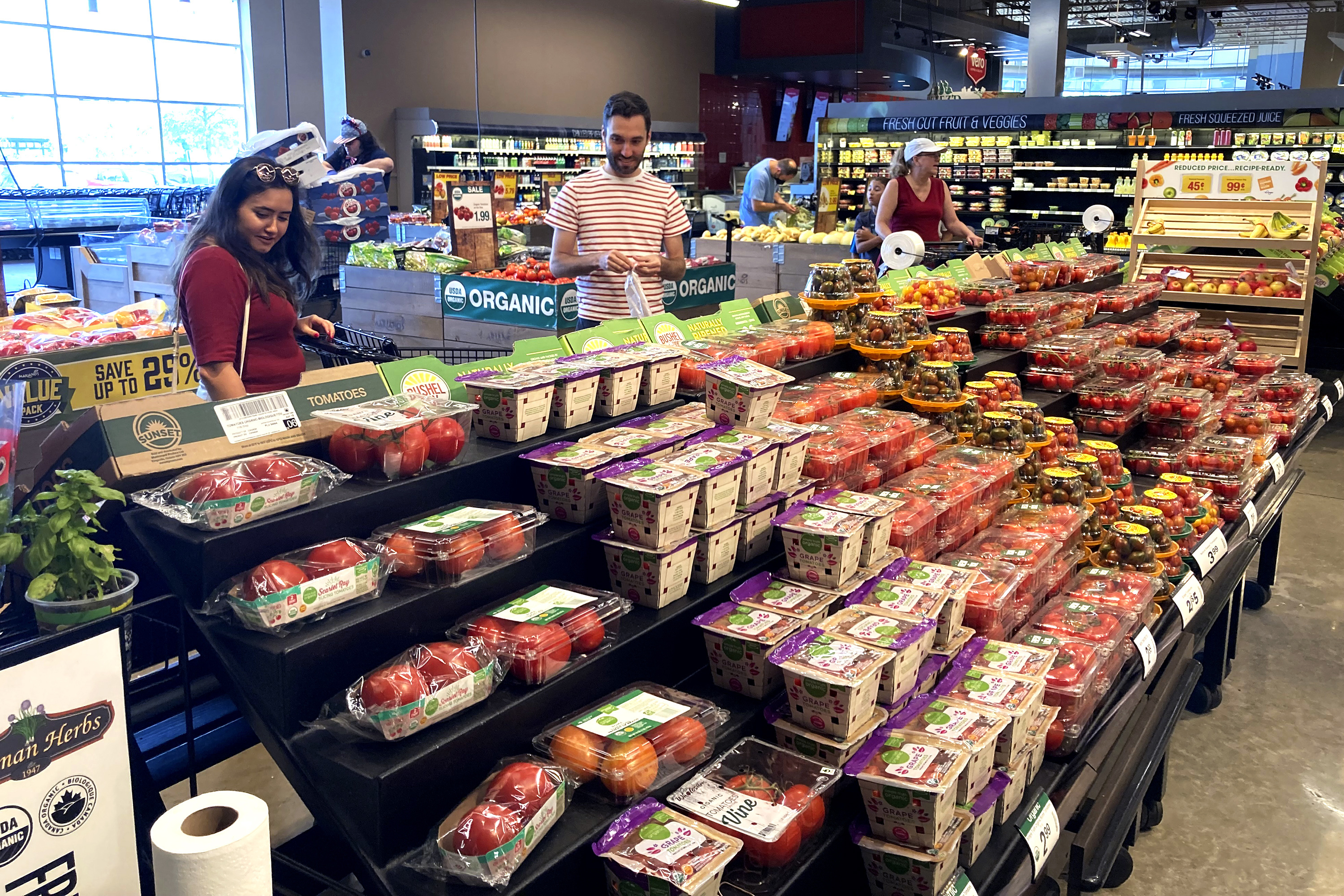 People shop at a grocery store in Glenview, Ill., July 4. The U.S. economy grew at a 2.6% annual rate from July through September, snapping two straight quarters of economic contraction, the government reported Thursday.
