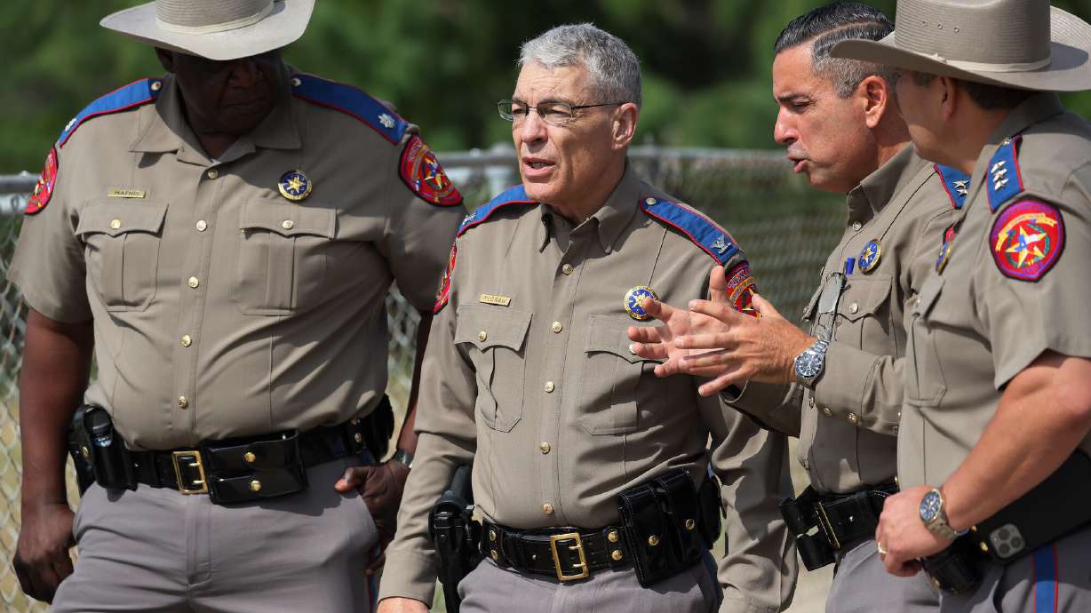 Steven McCraw, center, the Texas Department of Public Safety's top official, delivered the first formal, public update to his agency's oversight panel on its officers' actions during the May massacre at a Uvalde elementary school. He declined calls from victims' families to resign.