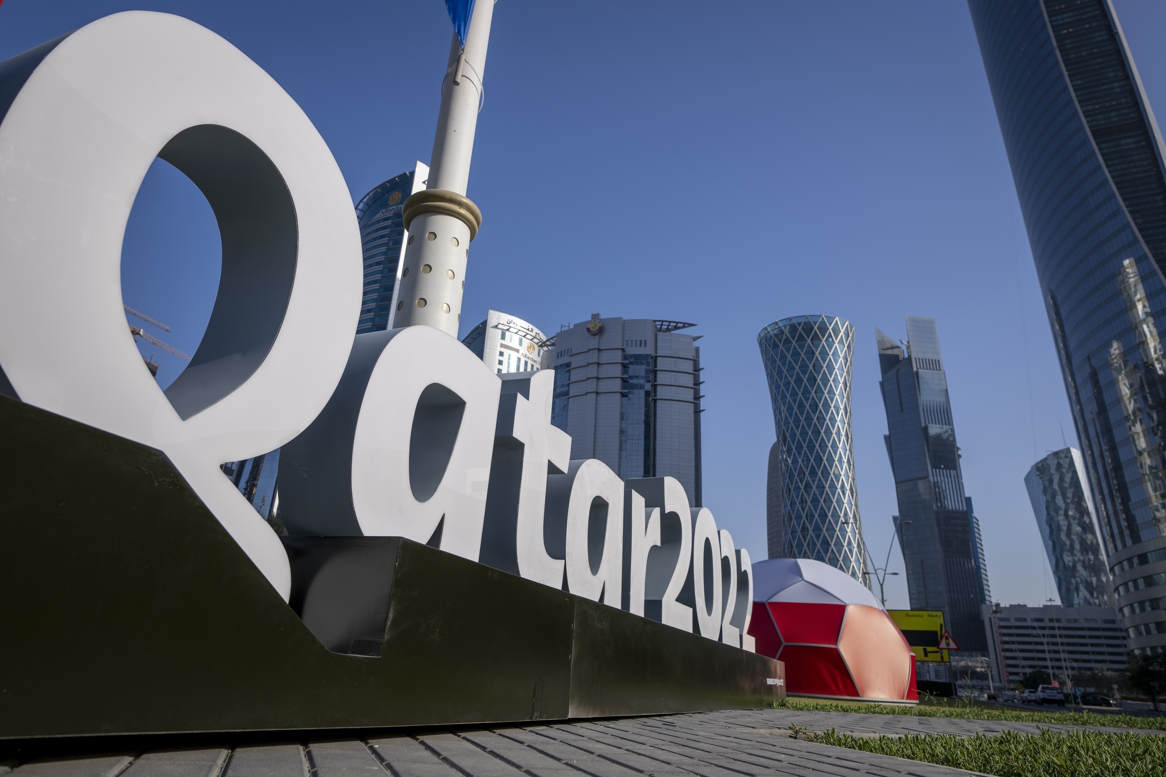 FILE - Branding is displayed near the Doha Exhibition and Convention Center in Doha, Qatar, Thursday, March 31, 2022. Qatar’s ruling emir has lashed out at criticism of the country over its hosting of the 2022 FIFA World Cup, complaining of an “unprecedented campaign” targeting the first Arab nation to hold the tournament. 